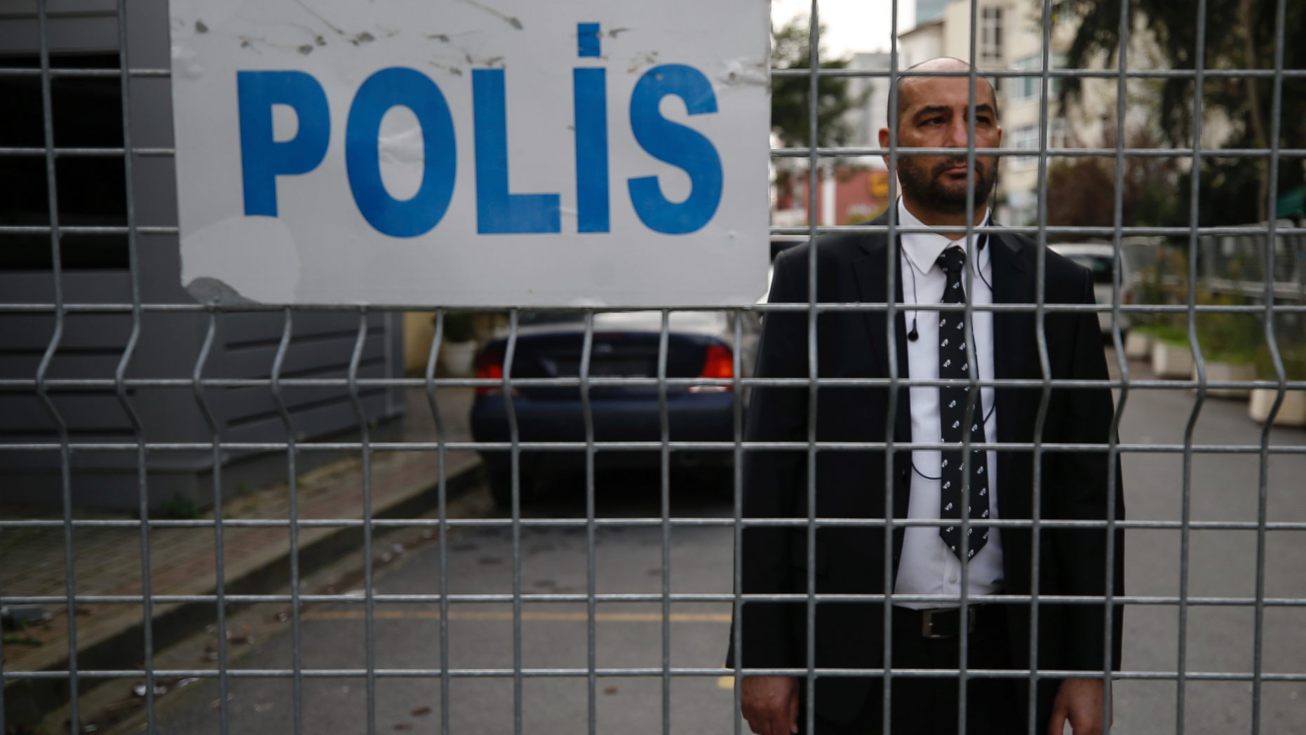 A security guard stands behind barriers blocking the road leading to Saudi Arabia's consulate in Istanbul, Saturday, Oct. 20, 2018. Turkey will "never allow a cover-up" of the killing of Saudi journalist Jamal Khashoggi in Saudi Arabia's consulate in Istanbul, a senior official in Turkey's ruling party said Saturday after Saudi Arabia announced hours earlier that the writer died during a "fistfight" in its consulate. (AP Photo/Emrah Gurel)