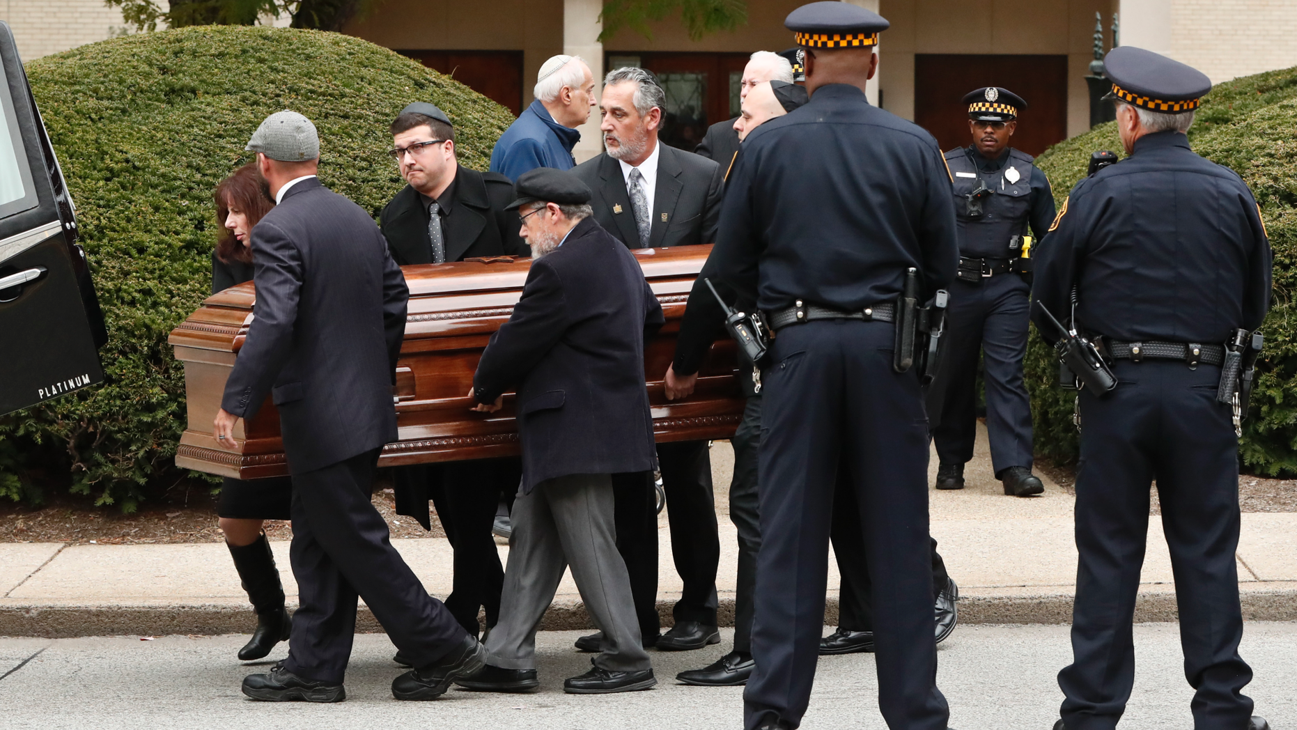Pittsburgh police stand guard as pallbearers carry the casket of Irving Younger, 69, from Congregation Rodef Shalom after his funeral on Wednesday, Oct. 31, 2018, in Pittsburgh. Younger was one of the eleven victims killed in the deadly shooting at a synagogue in Pittsburgh's Squirrel Hill neighborhood on Saturday. (AP Photo/Keith Srakocic)