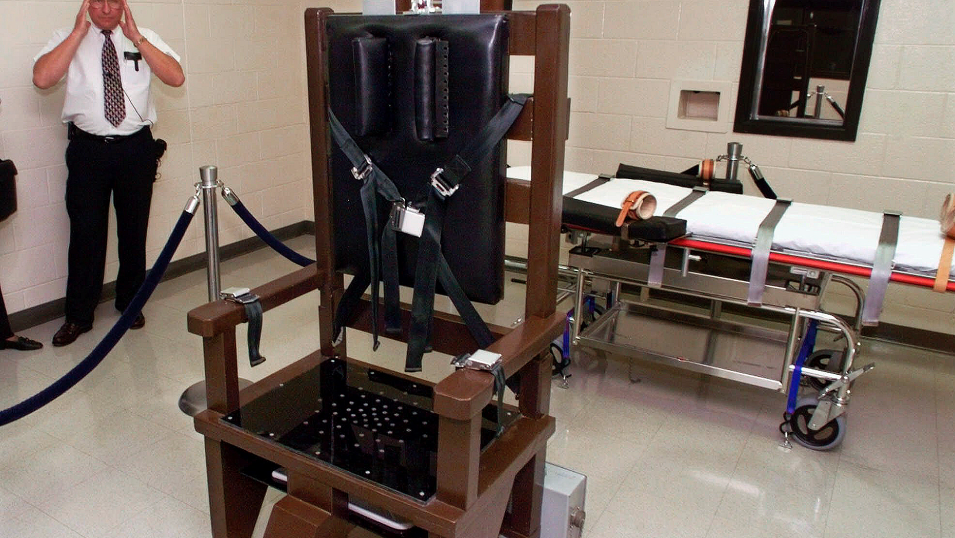 FILE - In this Oct. 13, 1999, file photo, Ricky Bell, then the warden at Riverbend Maximum Security Institution in Nashville, Tenn., gives a tour of the prison's execution chamber. Attorneys for Tennessee death row inmate Edmund Zagorski on Wednesday, Oct. 10, 2018, asked a federal court to force the state to use the electric chair to execute him, rather than lethal injection. The court battle over his Thursday execution played out over a solemn background in which prison staff and volunteers said the death of the well liked inmate will leave an impact. (AP Photo/Mark Humphrey, File)