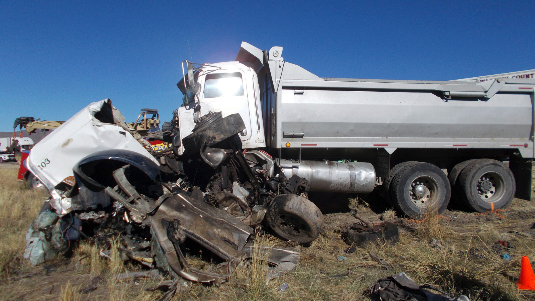 This Friday, Oct. 19, 2018 photo provided by the Utah Highway Patrol shows the scene of a head-on collision of a dump truck and a pickup on a state highway near Heber, Utah. State troopers say the dump truck crossed a highway median and collided with the pickup truck traveling in the opposite direction, killing all six men in the pickup in an accident authorities suspect may was caused by alcohol and prescription drugs. The Utah Highway Patrol said Saturday its officers found prescription pills and open containers of alcohol inside the dump truck. (Utah Highway Patrol via AP)