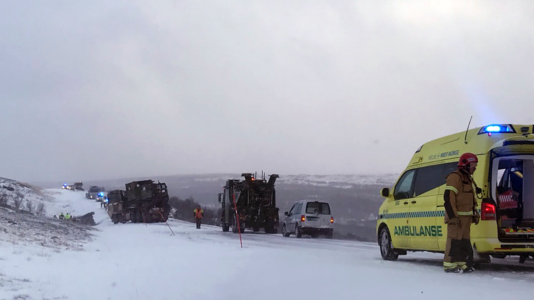 Emergency services attend the scene after four soldiers were injured during the NATO exercise Trident Juncture at Stuggusjoen in Tydal, Norway, Tuesday, Oct. 23, 2018. A report says multiple military vehicles were involved in the accident Tuesday in conjunction with exercise.(Ola Haakon Oestby / NTB scanpix via AP)
