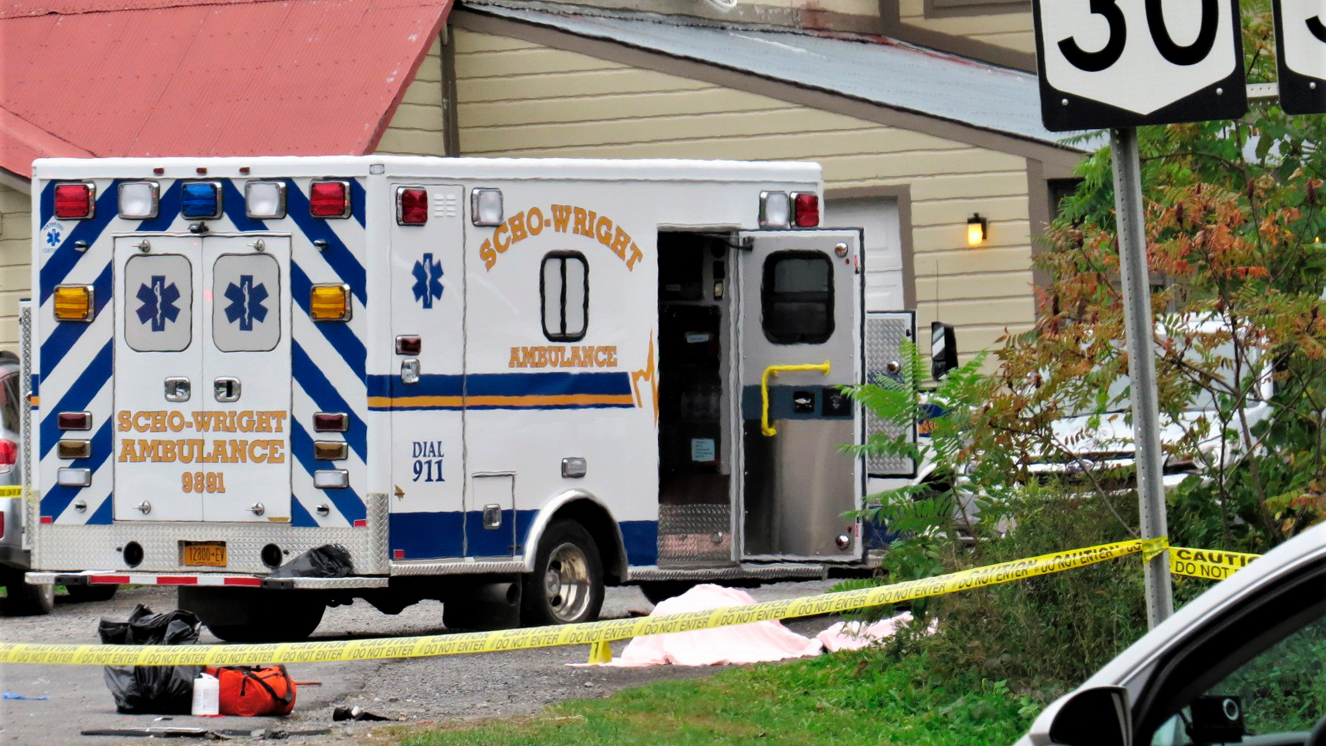 FILE - In this Saturday, Oct. 6, 2018 file photo, a body is draped under a blanket at the scene of a fatal crash in Schoharie, N.Y. A criminal case is preventing federal safety officials from conducting a full examination of the limousine involved in a crash that killed 20 people nearly two weeks ago in upstate New York.(Tom Heffernan Sr. via AP, File)