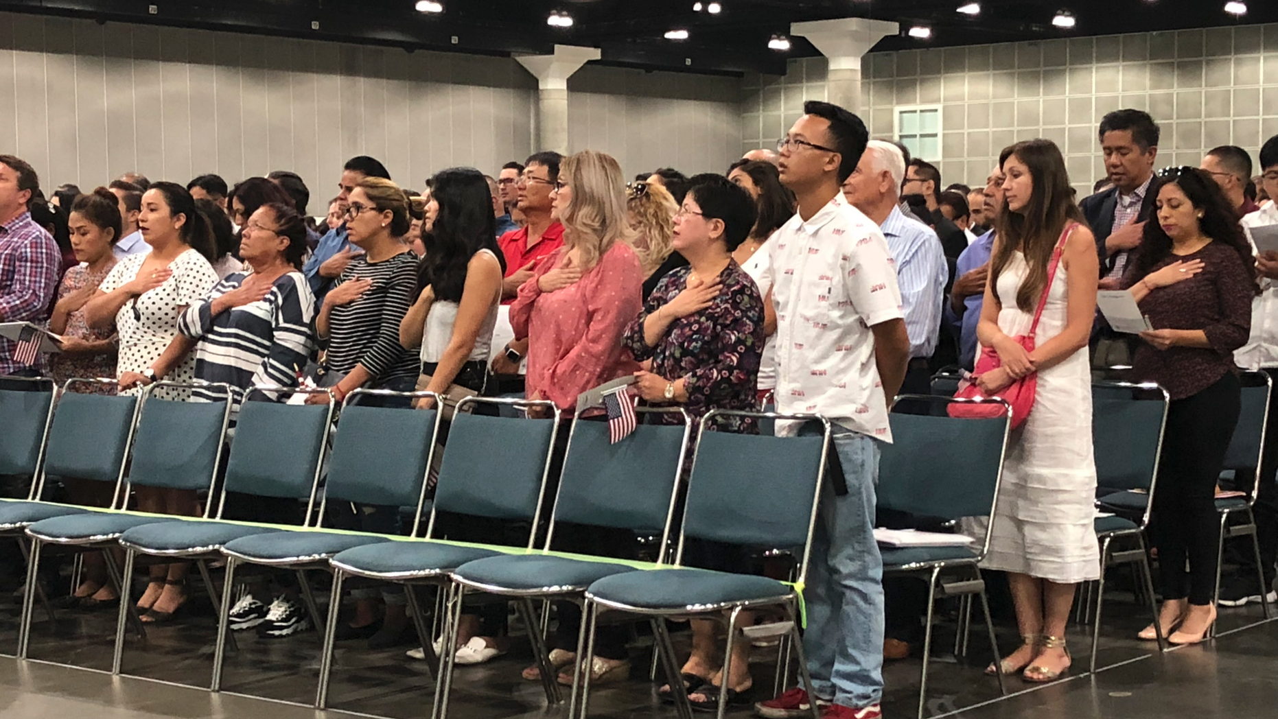 In this Sept. 18, 2018 photo new American citizens stand during a naturalization ceremony in Los Angeles. More than 700,000 immigrants are waiting on their applications to become U.S. citizens, a process that in many parts of the country now takes a year or more. The number of aspiring Americans surged during 2016, jumping 27 percent from a year ago as Donald Trump made cracking down on immigration a central point of his presidential campaign. (AP Photo/Amy Taxin)