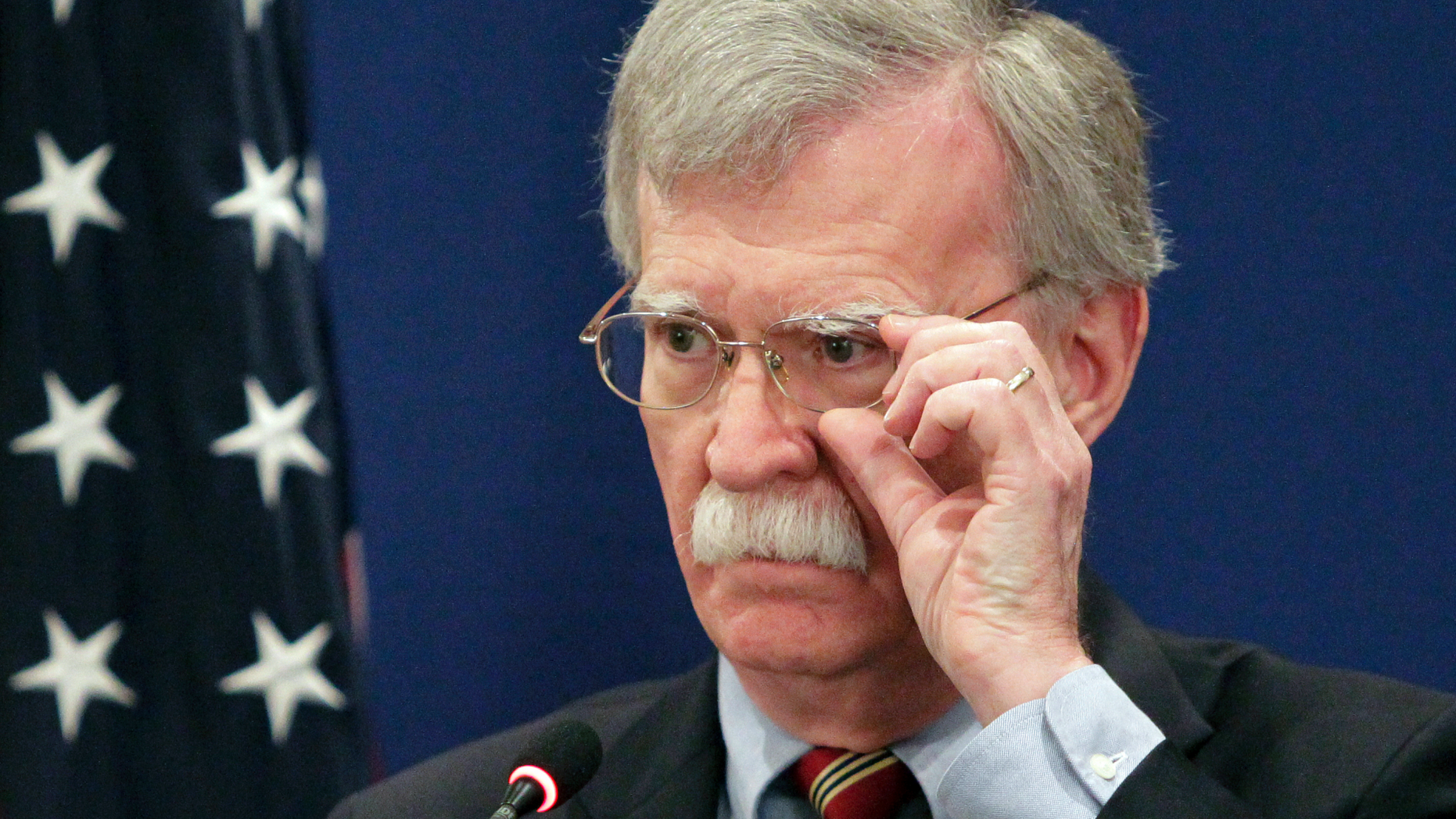 U.S. National security adviser John Bolton adjusts his glasses while speaking to the media during a news briefing following his meetings with Georgian officials in Tbilisi, Georgia, Friday, Oct. 26, 2018. (AP Photo/Shakh Aivazov)