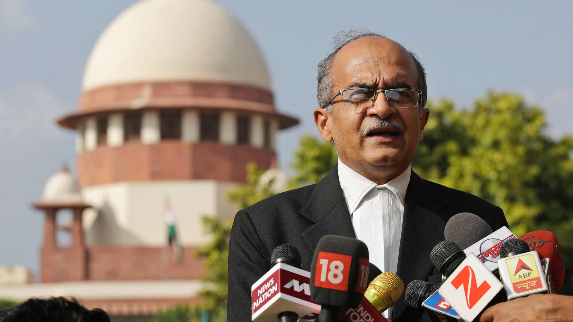 FILE - In this Sept. 4, 2017 file photo, Indian lawyer and social activist Prashant Bhushan speaks to the journalists about the petition filed by two Rohingya Muslim refugees against their deportation to Myanmar, outside the Supreme Court in New Delhi, India. India's top court has allowed the federal government to send seven Rohingya Muslims back to Myanmar in the first deportation of members of the Myanmar minority group since it last year ordered their identification. The Supreme Court on Thursday, Oct. 4, 2018 rejected a plea by Bhushan, a defense attorney, to let them live in India as they feared reprisal in Myanmar. They were arrested in 2012 for entering India illegally and have been held in a prison. (AP Photo/Tsering Topgyal, File)