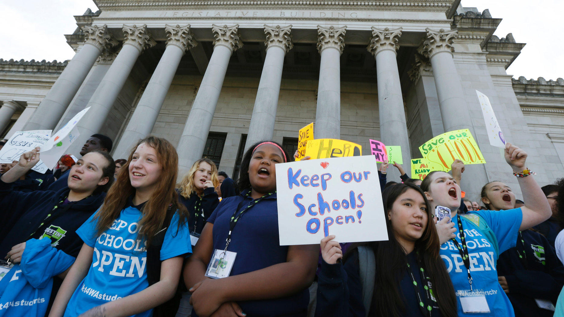 FILE - In this Feb. 25, 2016, file photo, children hold signs during a rally in support of charter schools at the Capitol in Olympia, Wash. On Thursday, Oct. 25, 2018, the Washington Supreme Court upheld most of the state's charter school law, eliminating the specter that the classrooms serving more than 3,000 students might have to close. (AP Photo/Ted S. Warren, File)