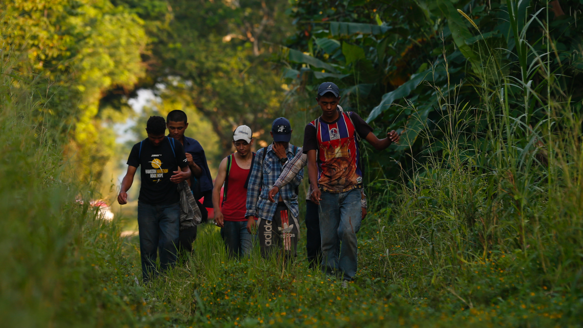 A small group of Honduran migrants trying to reach the U.S. border walk along train tracks in Trancas Viejas, Veracruz state, Wednesday, Oct. 24, 2018. As a caravan of thousands of Central Americans renewed their slow march toward the U.S. on Wednesday, others chose to travel in smaller groups following routes well-worn by decades of migrants fleeing poverty and violence.(AP Photo/Rebecca Blackwell)