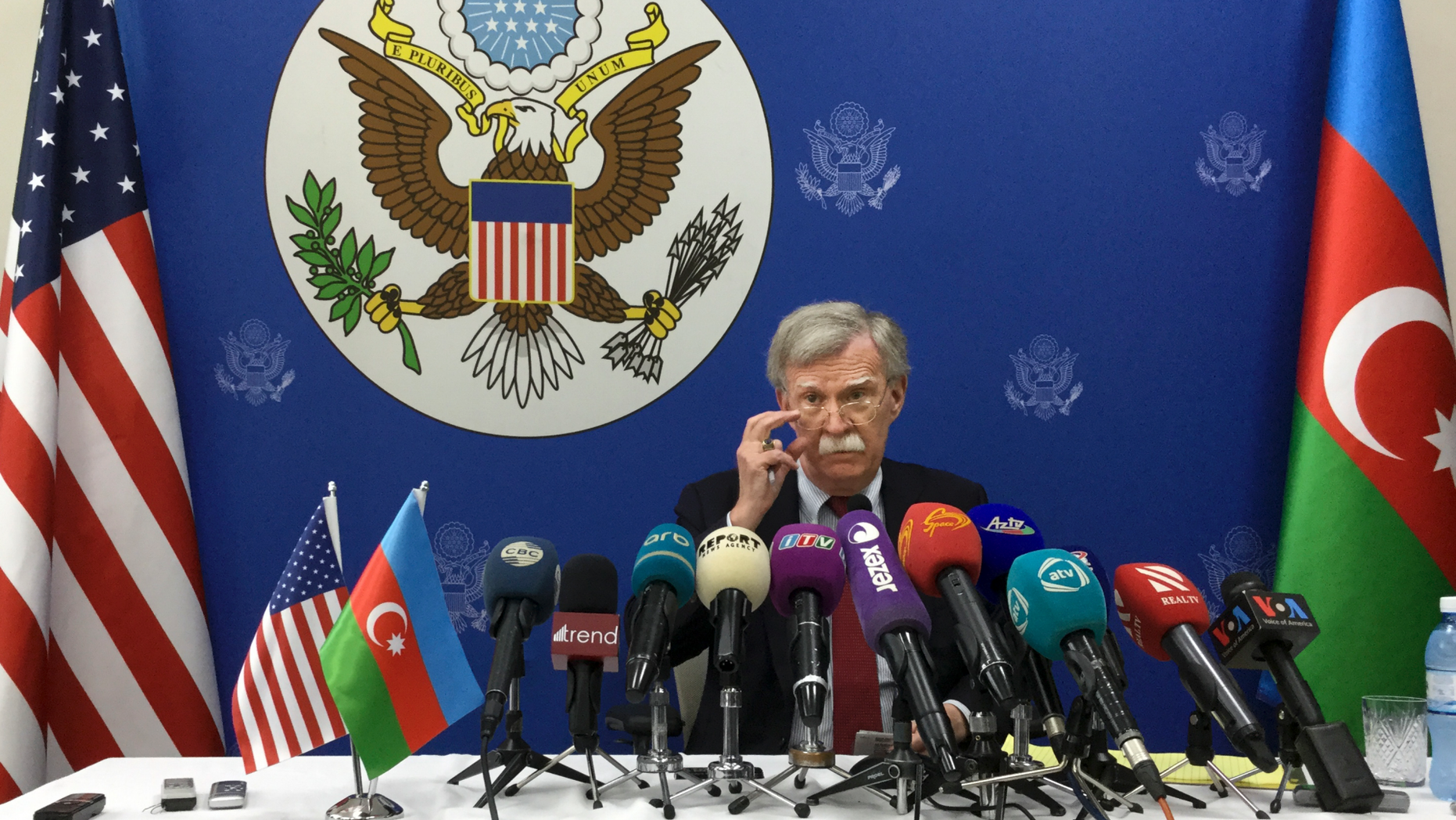 U.S. National security adviser John Bolton adjusts his glasses while speaking to the media after his talks with Azerbaijan's President Ilham Aliyev in Baku, Azerbaijan, Wednesday, Oct. 24, 2018. Bolton said that Washington hasn't yet made up its mind on further sanctions against Russia over the poisoning of an ex-Russian spy in Britain. (AP Photo/Aida Sultanova)