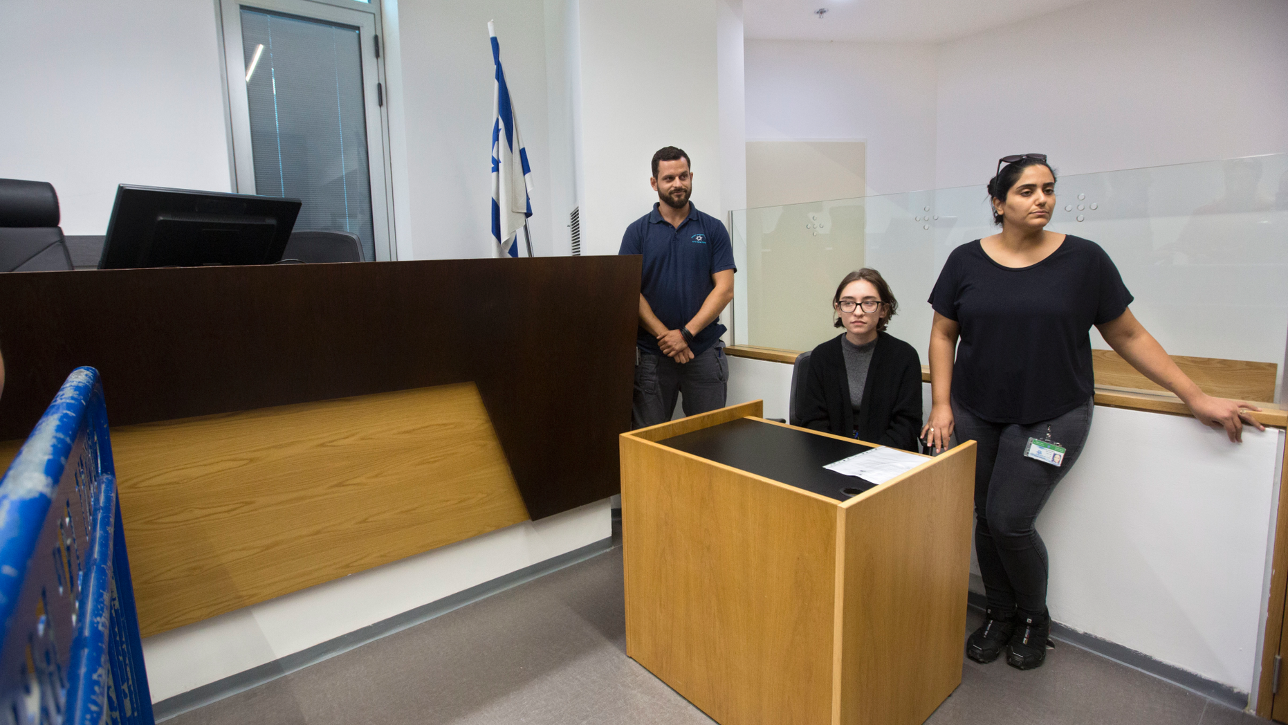 American Lara Alqasem, center, sits in a courtroom prior to a hearing at the district court in Tel Aviv, Israel, Thursday, Oct. 11, 2018. A senior Israeli cabinet minister on Wednesday defended the government's handling of the case of an American graduate student held in detention at the country's international airport for the past week over allegations that she promotes a boycott against the Jewish state. (AP Photo/Sebastian Scheiner)