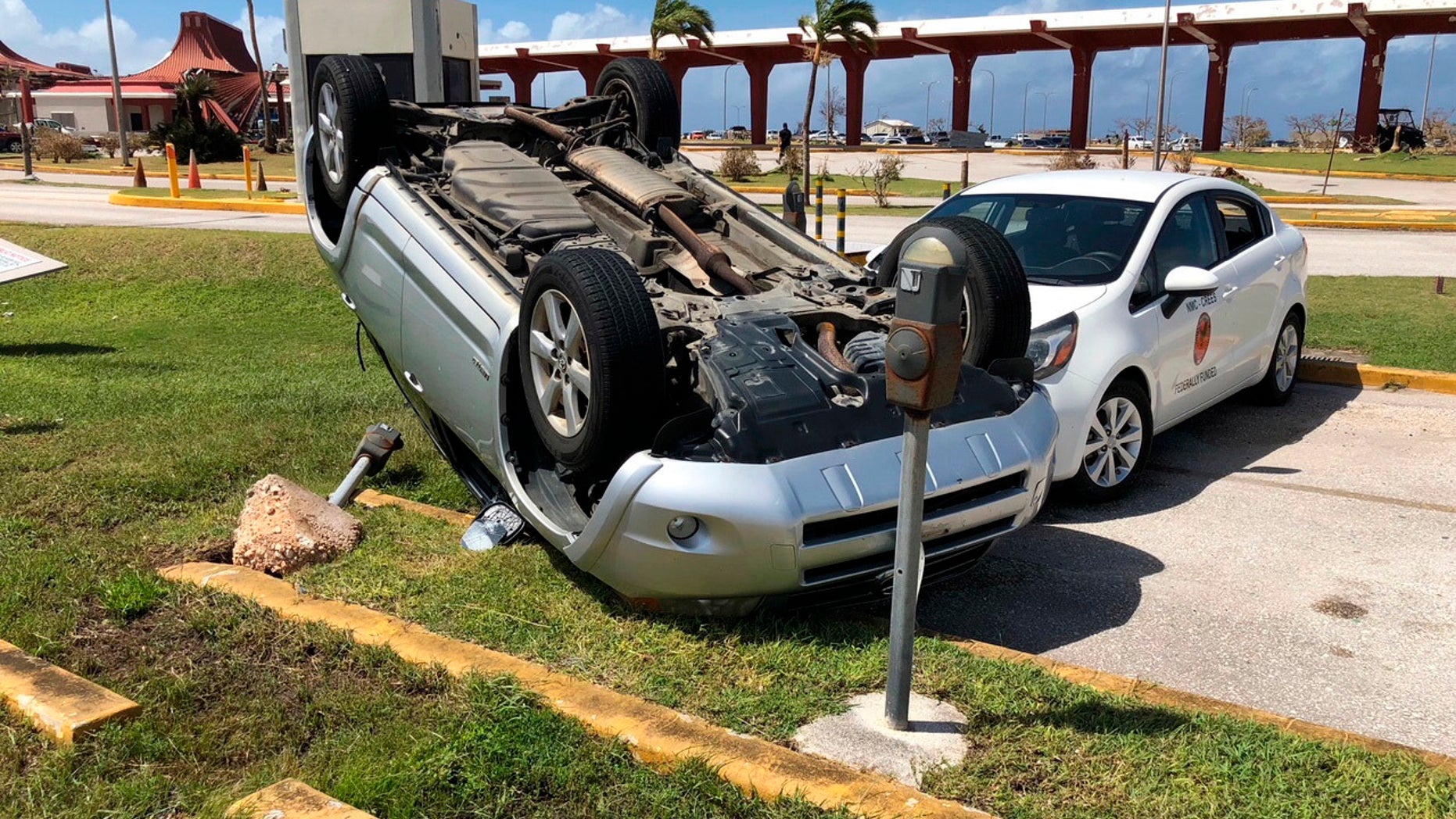 An overturned car is shown at the airport after Super Typhoon Yutu hit the U.S. Commonwealth of the Northern Mariana Islands, Friday, Oct. 26, 2018, in Garapan, Saipan. Residents of the U.S. territory are preparing for months without electricity or running water after the islands were slammed with the strongest storm on Thursday to hit any part of the U.S. this year. (AP Photo/Dean Sensui)