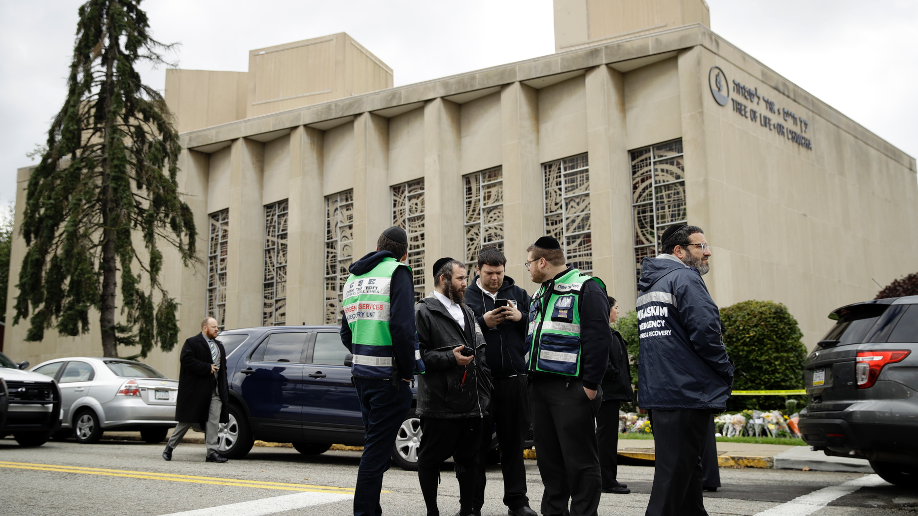 Personnel from Chesed Shel Emes Emergency Services and Recovery Unit gather near the Tree of Life Synagogue in Pittsburgh, Sunday, Oct. 28, 2018. Robert Bowers, the suspect in the mass shooting at the synagogue, expressed hatred of Jews during the rampage and told officers afterward that Jews were committing genocide and he wanted them all to die, according to charging documents made public Sunday. (AP Photo/Matt Rourke)