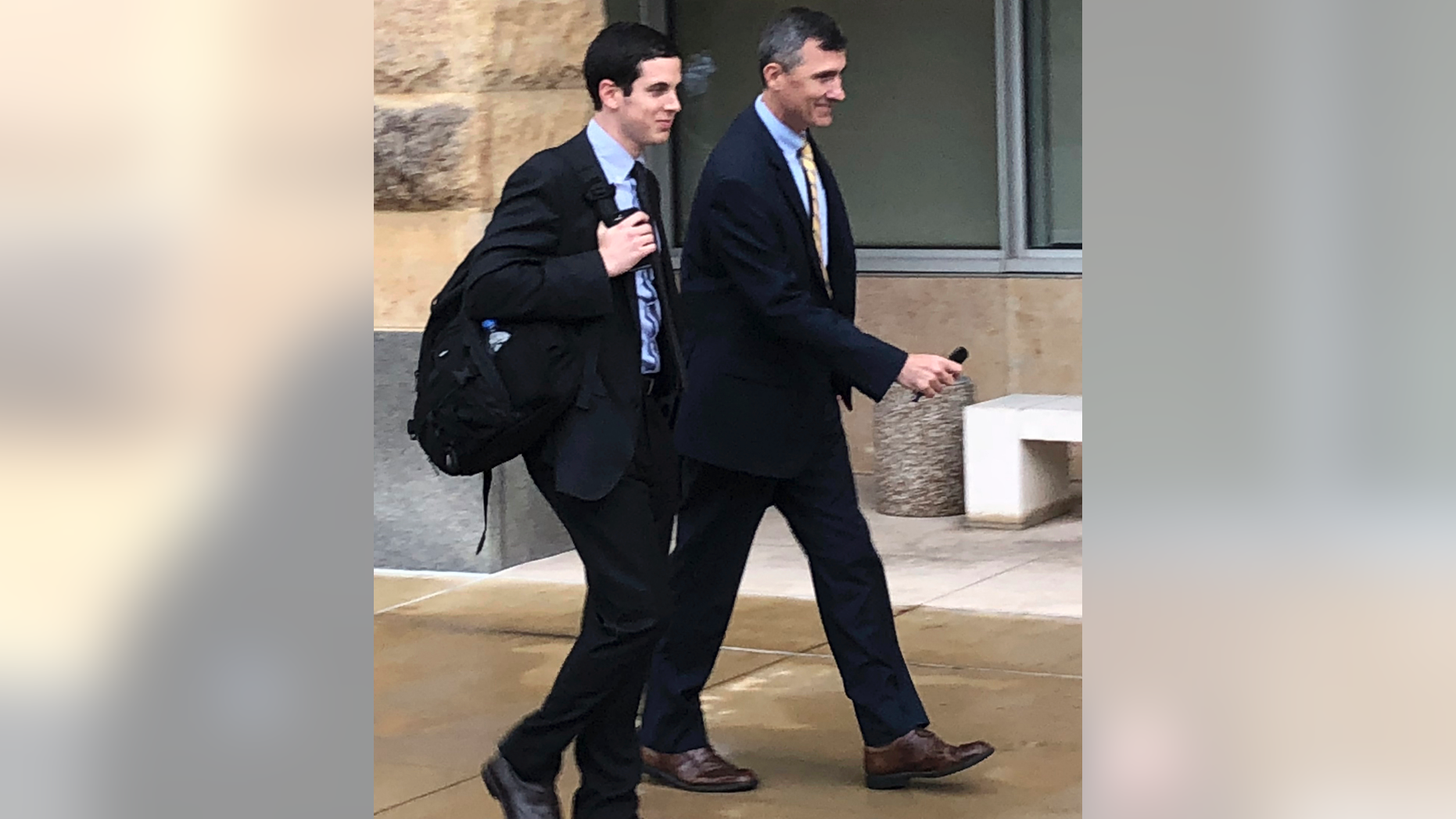 Dennis Boyle, left, and Blerina Jasari, lawyers for Dawn Bennett, walk outside the federal courthouse, Thursday, Oct. 11, 2018, in Greenbelt, Md. Authorities and a government witness say that Bennett cast paranormal spells and spent nearly three-quarters of a million dollars on prayers in a desperate attempt to avoid charges that she orchestrated a multimillion-dollar Ponzi scheme. (AP Photo/Michael Kunzelman)