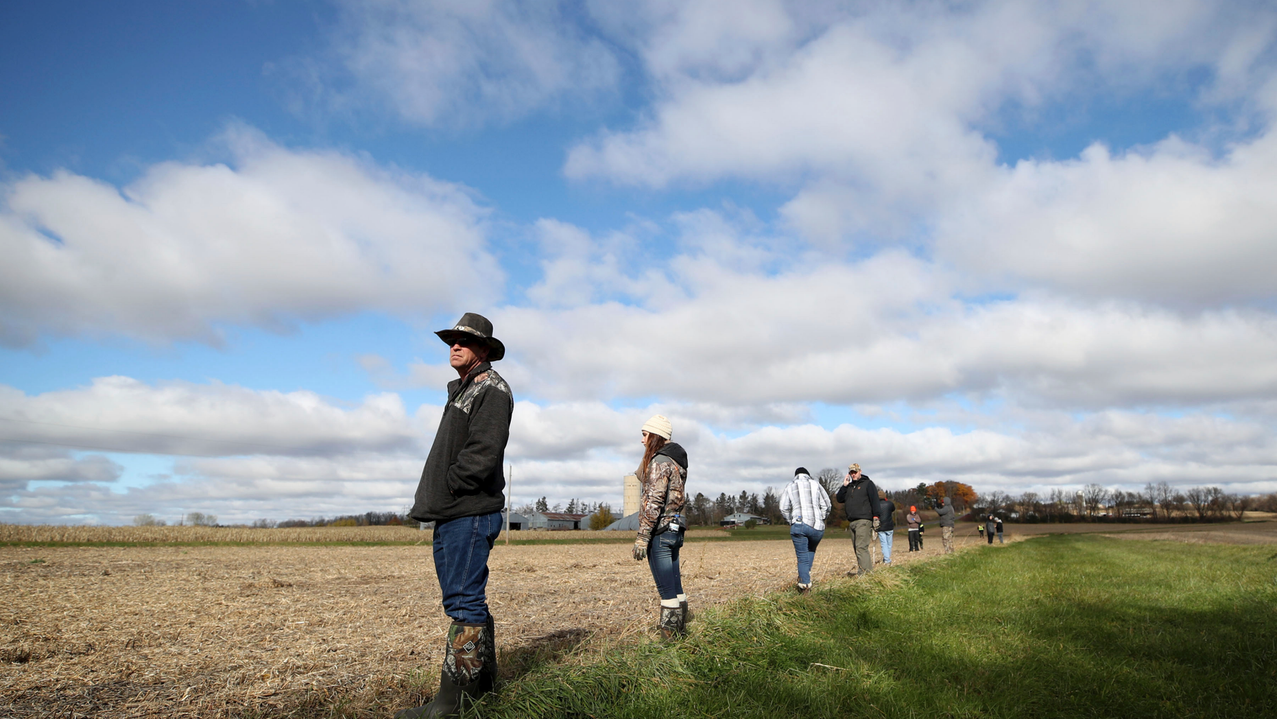 Louie Lauderdale, of Lake Geneva, Wis. searches near a cornfield along 15th Ave. near highway 25 just North of Barron, Wis., Tuesday, Oct. 23, 2018, for 13-year-old Jayme Closs, who was discovered missing Oct. 15 after her parents were found fatally shot at their home. (Jerry Holt/Star Tribune via AP)