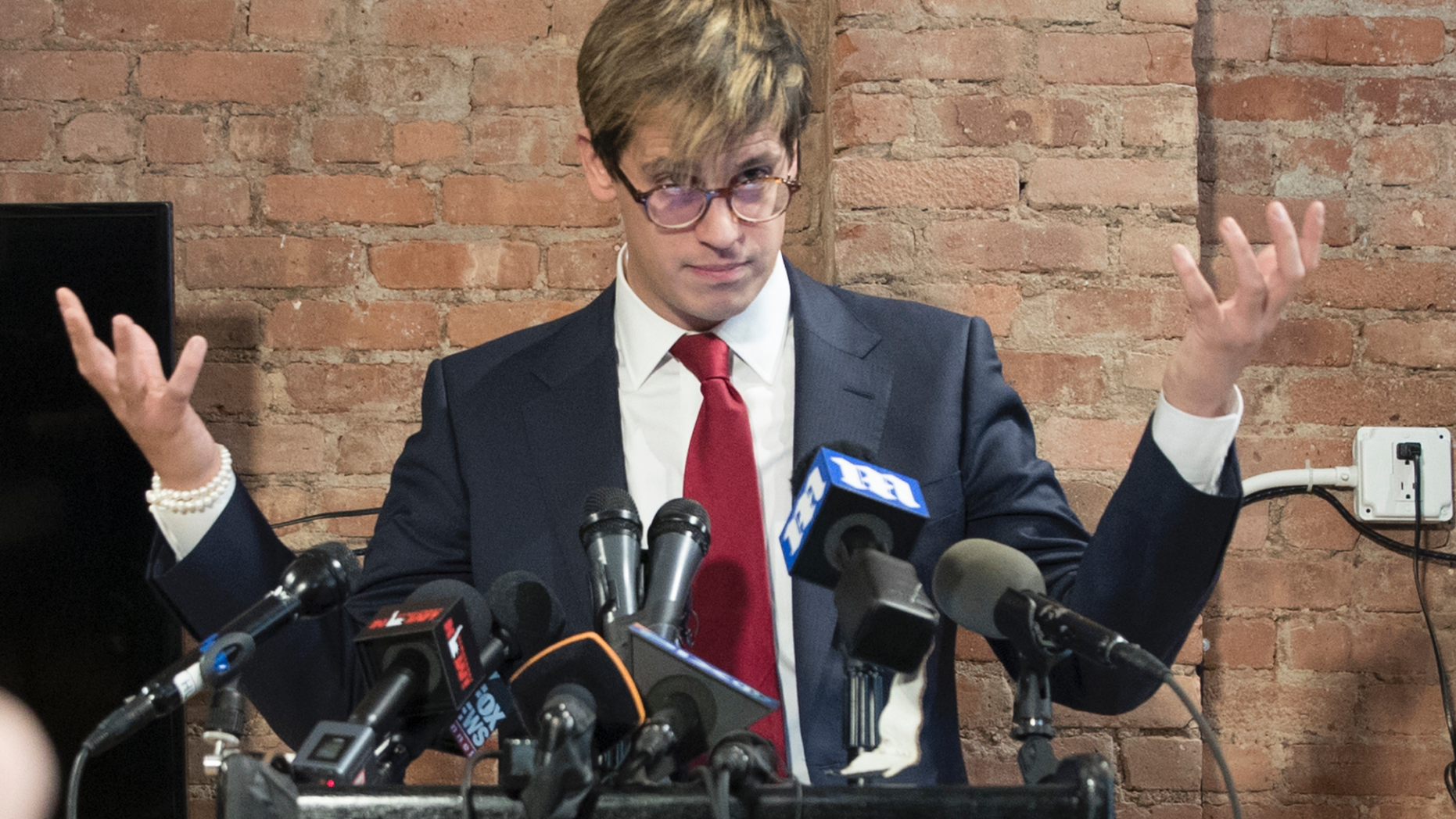 FILE- In this Feb. 21, 2017 file photo, Milo Yiannopoulos speaks during a news conference in New York. Citing safety concerns, New York University has postponed a speech by the right-wing provocateur that was scheduled for Halloween night, Wednesday, Oct. 31, 2018. (AP Photo/Mary Altaffer, File)