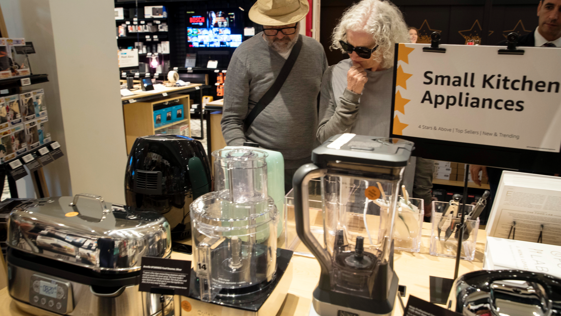 FILE- In this Sept. 27, 2018, file photo shoppers browse the items on display at the Amazon 4-star store in the Soho neighborhood of New York. On Tuesday, Oct. 30, the Conference Board releases its October index on U.S. consumer confidence. (AP Photo/Mary Altaffer, File)