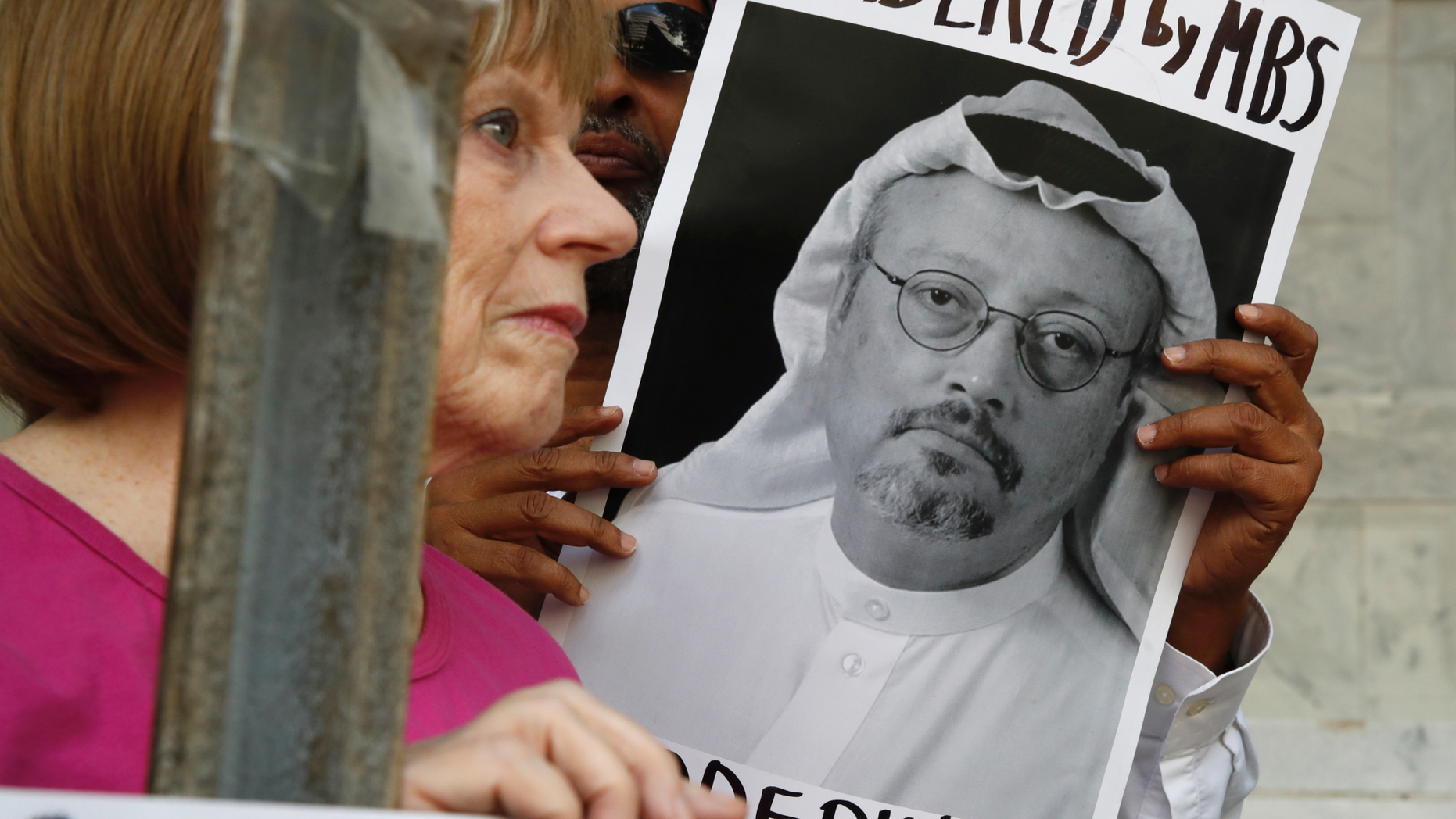 FILE - In this Oct. 10, 2018, file photo, people hold signs during a protest at the Embassy of Saudi Arabia about the disappearance of Saudi journalist Jamal Khashoggi, in Washington. The Trump administration’s ongoing courtship of Saudi Arabia is on pause over allegations that the key U.S. ally is involved in the mysterious disappearance of a Saudi writer and dissident who went into his nation’s consulate in Turkey but never came out. (AP Photo/Jacquelyn Martin, File )