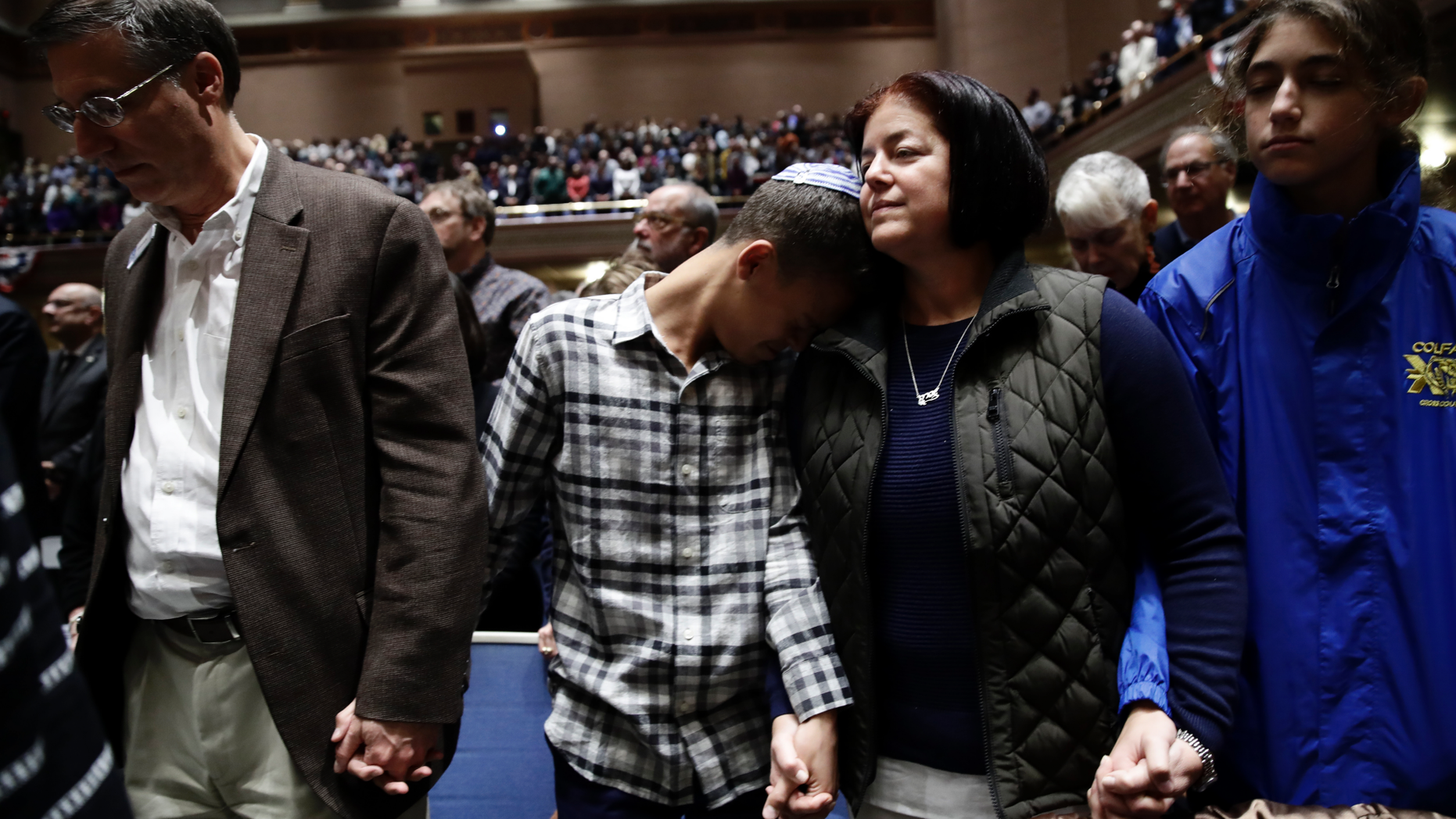 People mourn in Soldiers & Sailors Memorial Hall & Museum during a community gathering held in the aftermath of Saturday's deadly shooting at the Tree of Life Synagogue in Pittsburgh, Sunday, Oct. 28, 2018. (AP Photo/Matt Rourke)