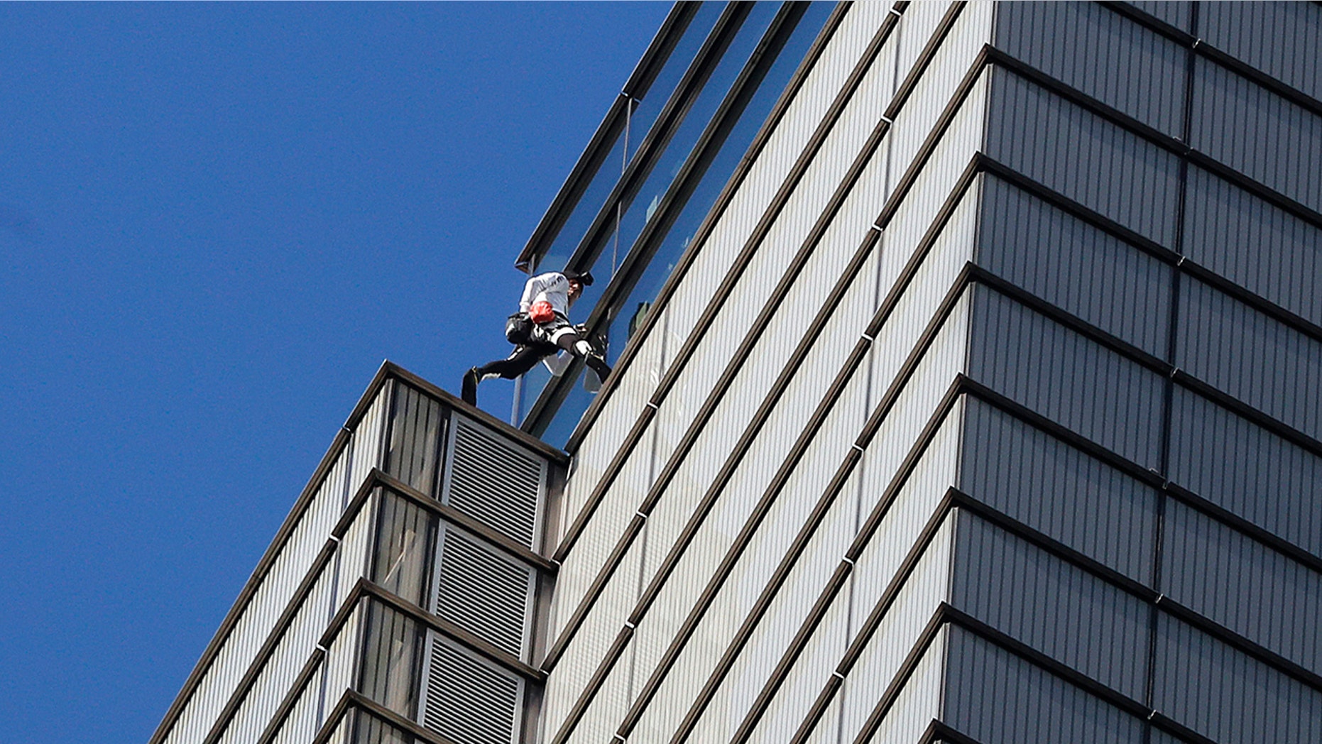 Alain Robert, an urban climber dubbed the "French Spider-Man," completes his climb of the outside of Heron Tower building in the City of London, Thursday, Oct. 25, 2018.
