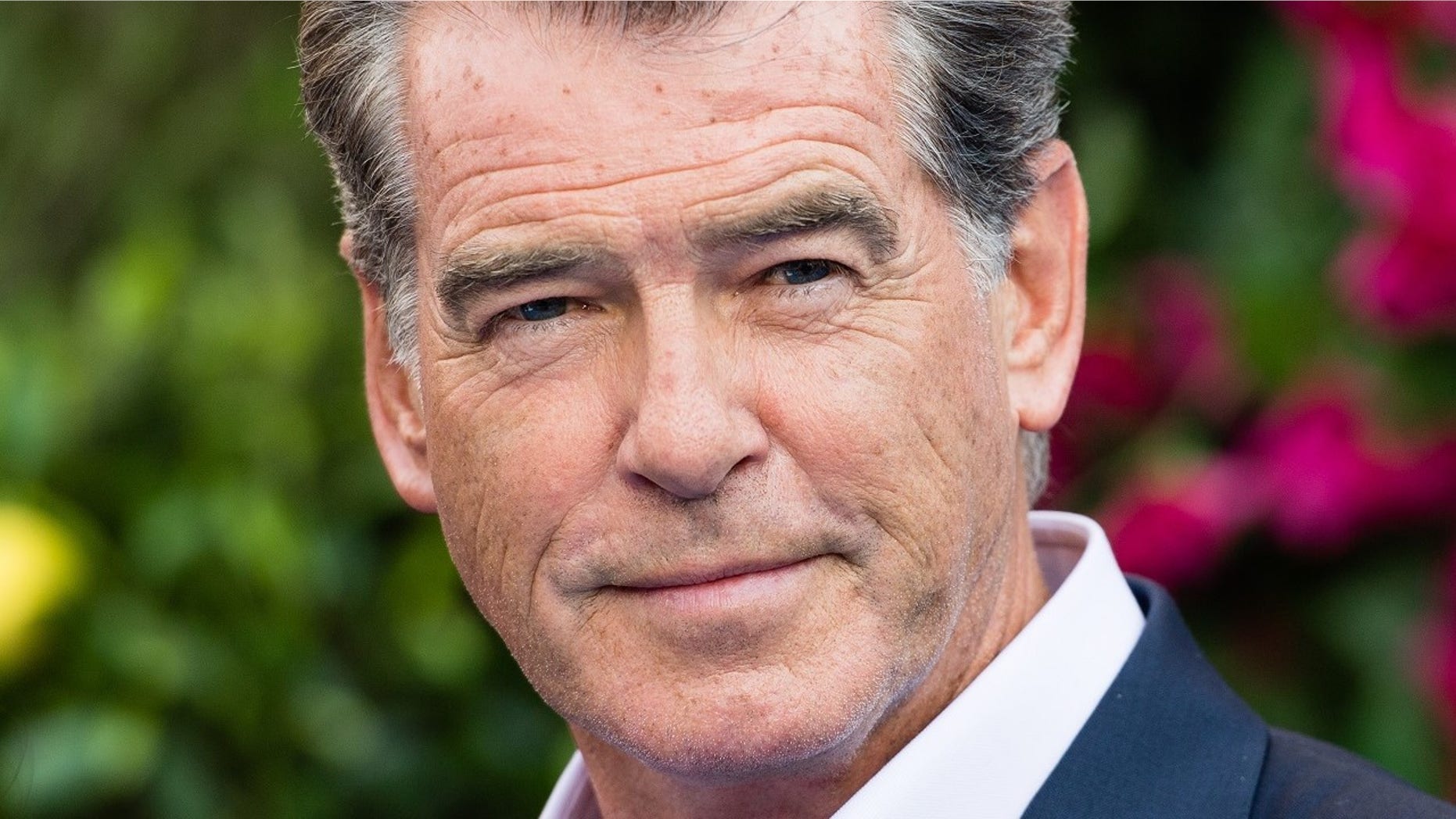Pierce Brosnan said he had a close encounter with a shark during his vacation in French Polynesia.