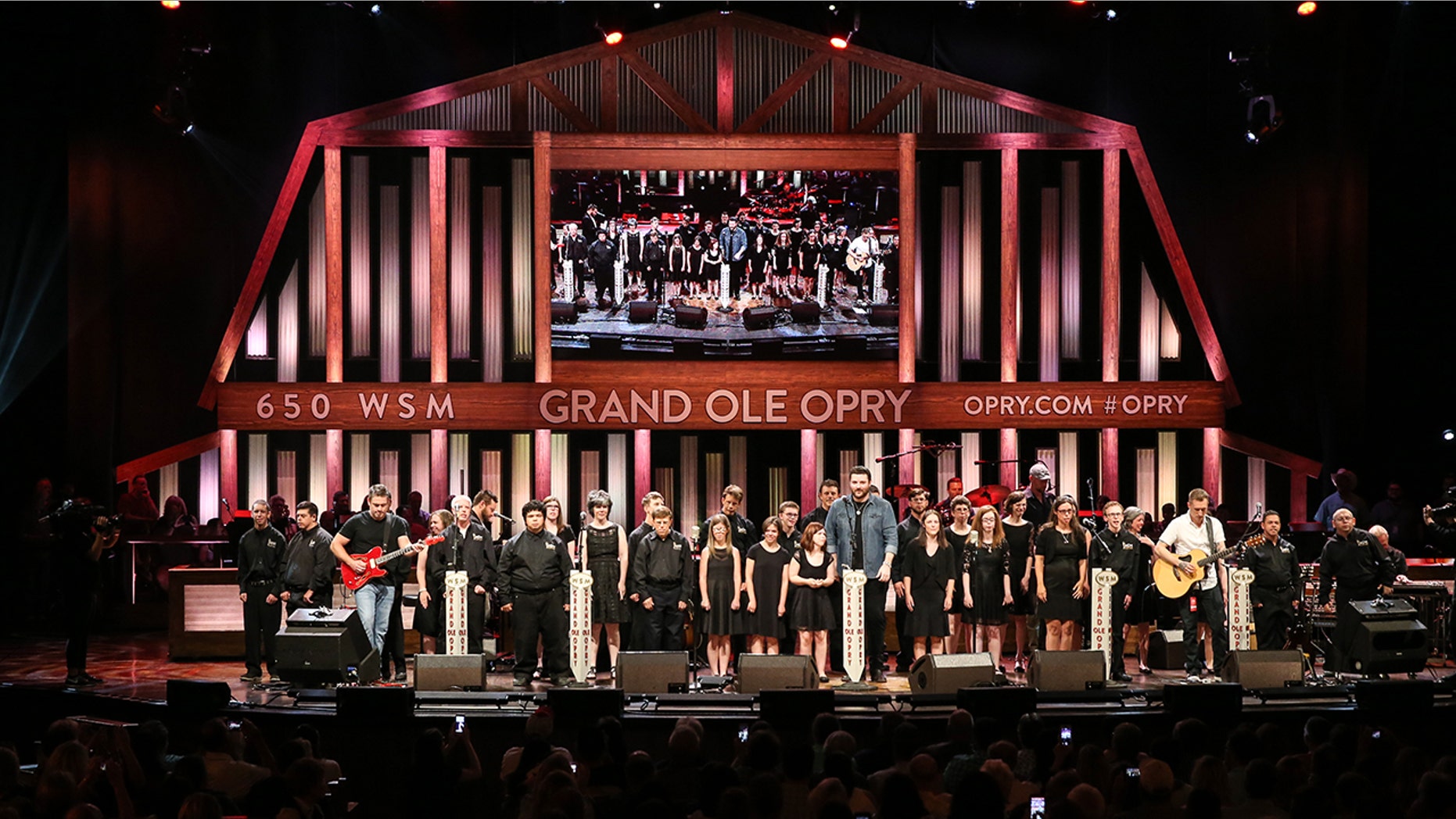 The Grand Ole Opry will help raise money for a fan battling cancer. Pictured is the ACM Lifting Lives music Campers joining Singer-songwriter Chris Young on stage during a Performance at Grand Ole Opry House on June 27, 2017 in Nashville, Tennessee.