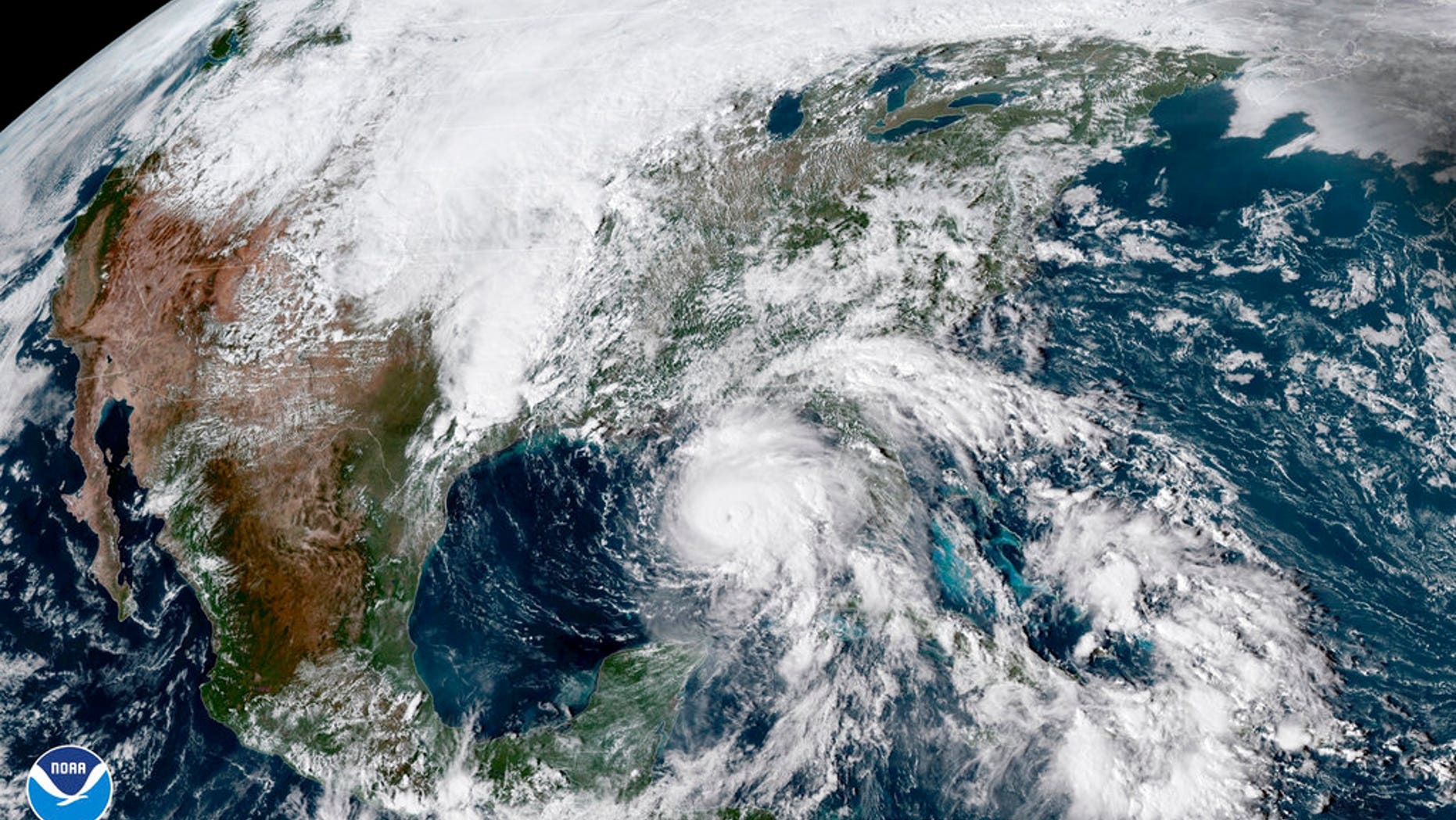 This satellite image made available by NOAA shows Hurricane Michael, center, in the Gulf of Mexico. (NOAA via AP)