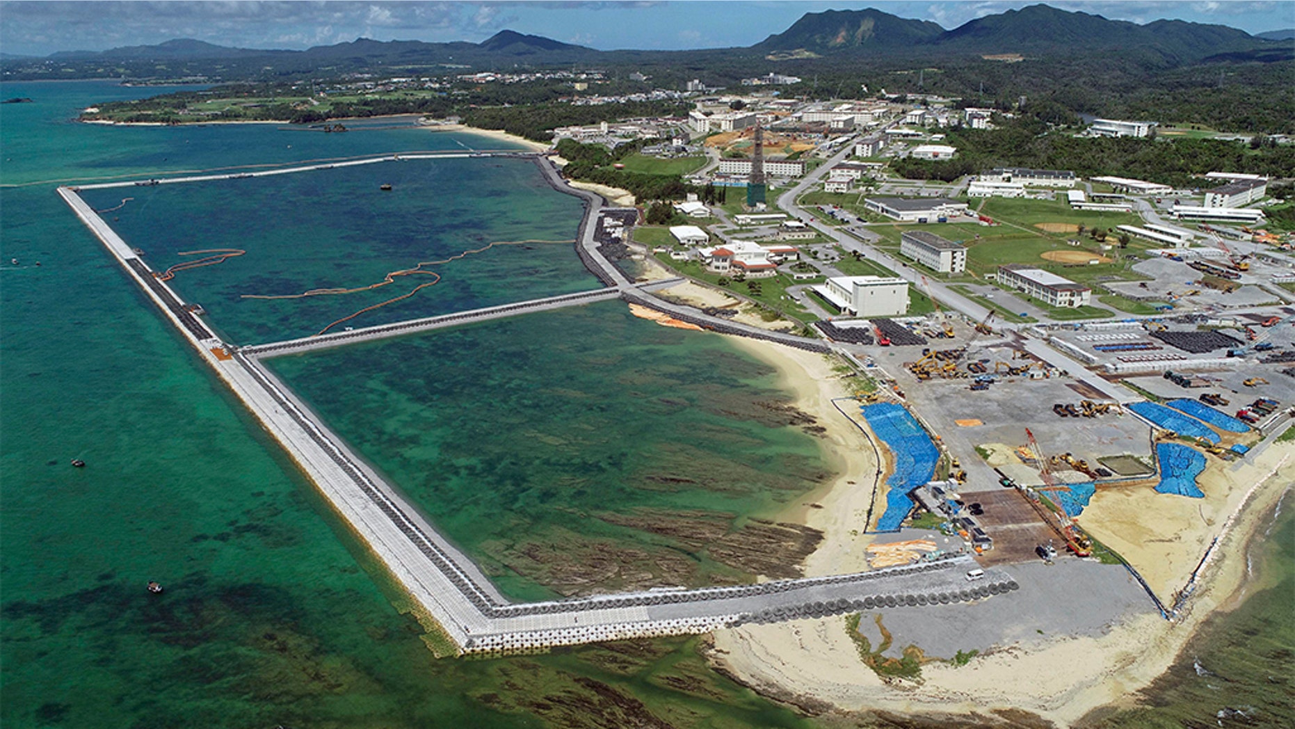 FILE - This Aug. 2018, file aerial photo shows preliminary construction work off Henoko, in Nago city, Okinawa prefecture, Japan, where the Japanese government plans to relocate a U.S. air base from one area of Okinawa's main island to another. Denny Tamaki, the newly elected governor of the southern Japanese island of Okinawa, was chosen in a Sept. 30 election, running on a campaign that rejected the U.S. base being built on coastal Henoko. He defeated, by a comfortable margin, the candidate backed by the ruling party, eager to go ahead with Henoko, whose construction has been on hold. (Koji Harada/Kyodo News via AP, File)