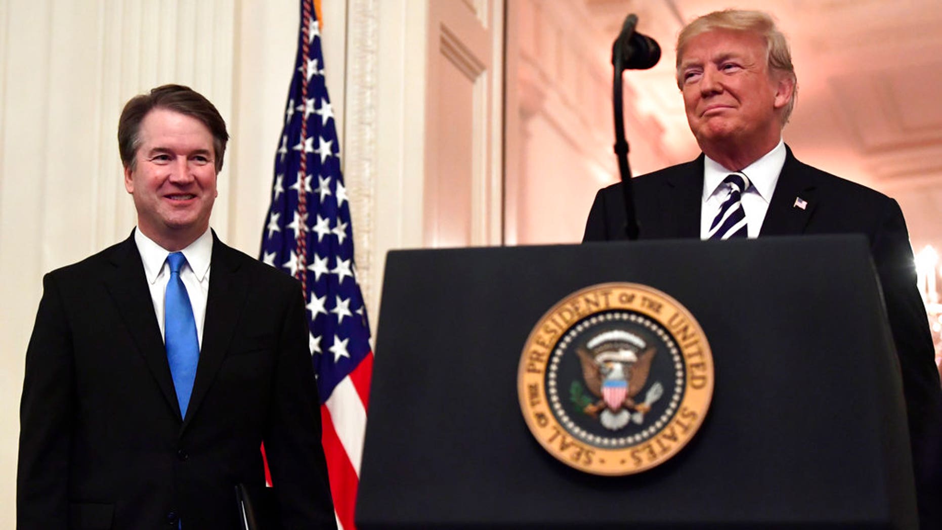 President Donald Trump, right, smiles as he stands with Supreme Court Justice Brett Kavanaugh, left, before a ceremonial swearing in in the East Room of the White House in Washington. (AP Photo/Susan Walsh)
