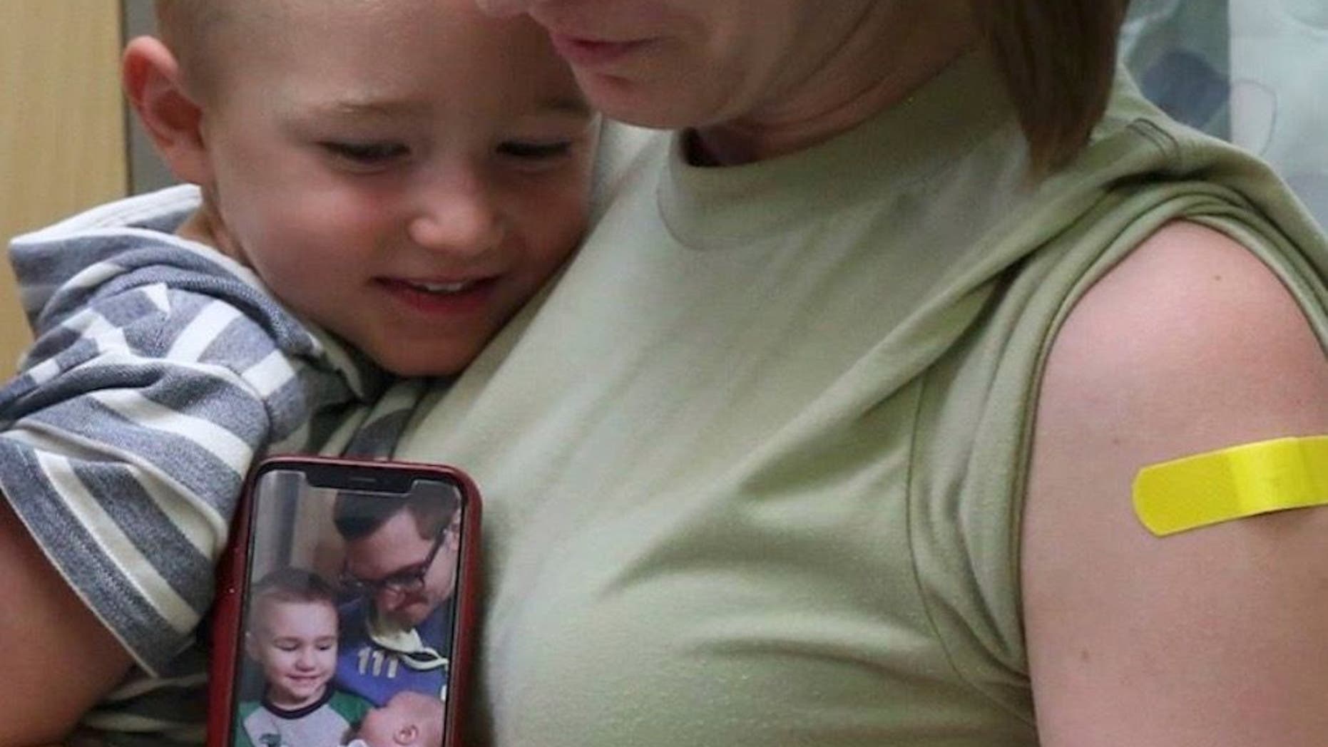 Laura Sidari, pictured holding one of her children and a photo of her husband with Leon, shortly after their second was born, is sharing the #FluShotsforLeon campaign after the boy died last year from complications of the virus.