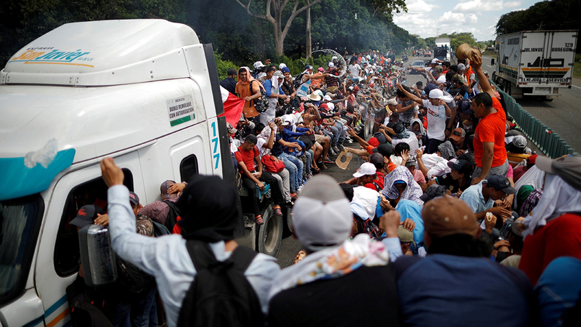Central American migrants, who are part of a caravan of migrants trying to reach the United States, hitchhike on a truck along the highway as they continued their journey in Tapachula, Mexico, earlier this week. 