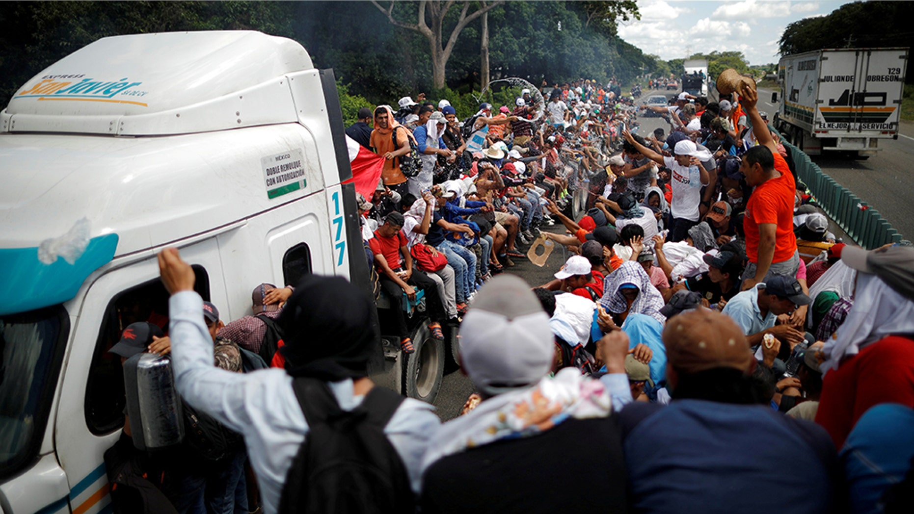 Central American migrants, who are part of a caravan of migrants trying to reach the United States, hitchhike on a truck along the highway as they continued their journey in Tapachula, Mexico, earlier this week.