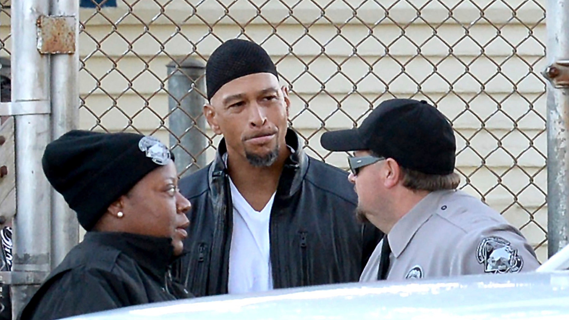 Former Carolina Panthers NFL football player Rae Carruth, center, exits the Sampson Correctional Institution in Clinton, N.C.