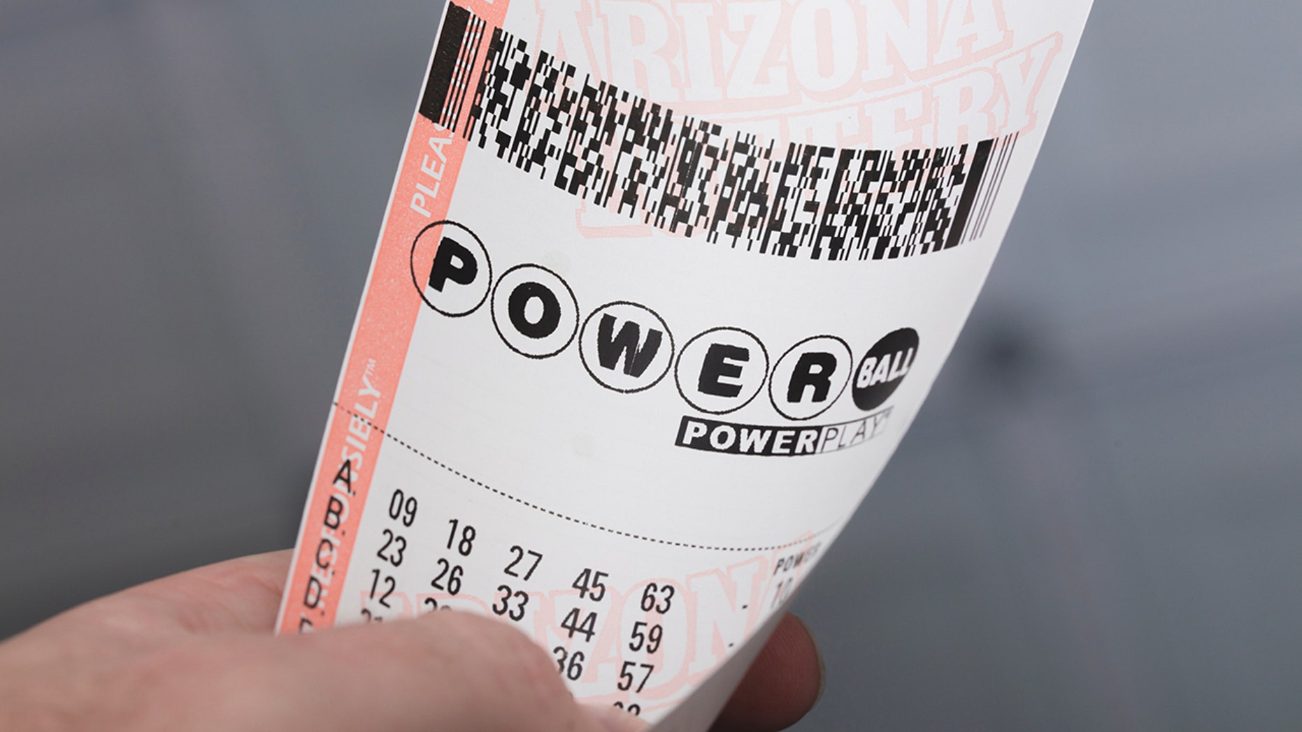 Kingman, USA - January 20, 2016: A photo of a man holding a Powerball Lottery ticket in Kingman, Arizona.