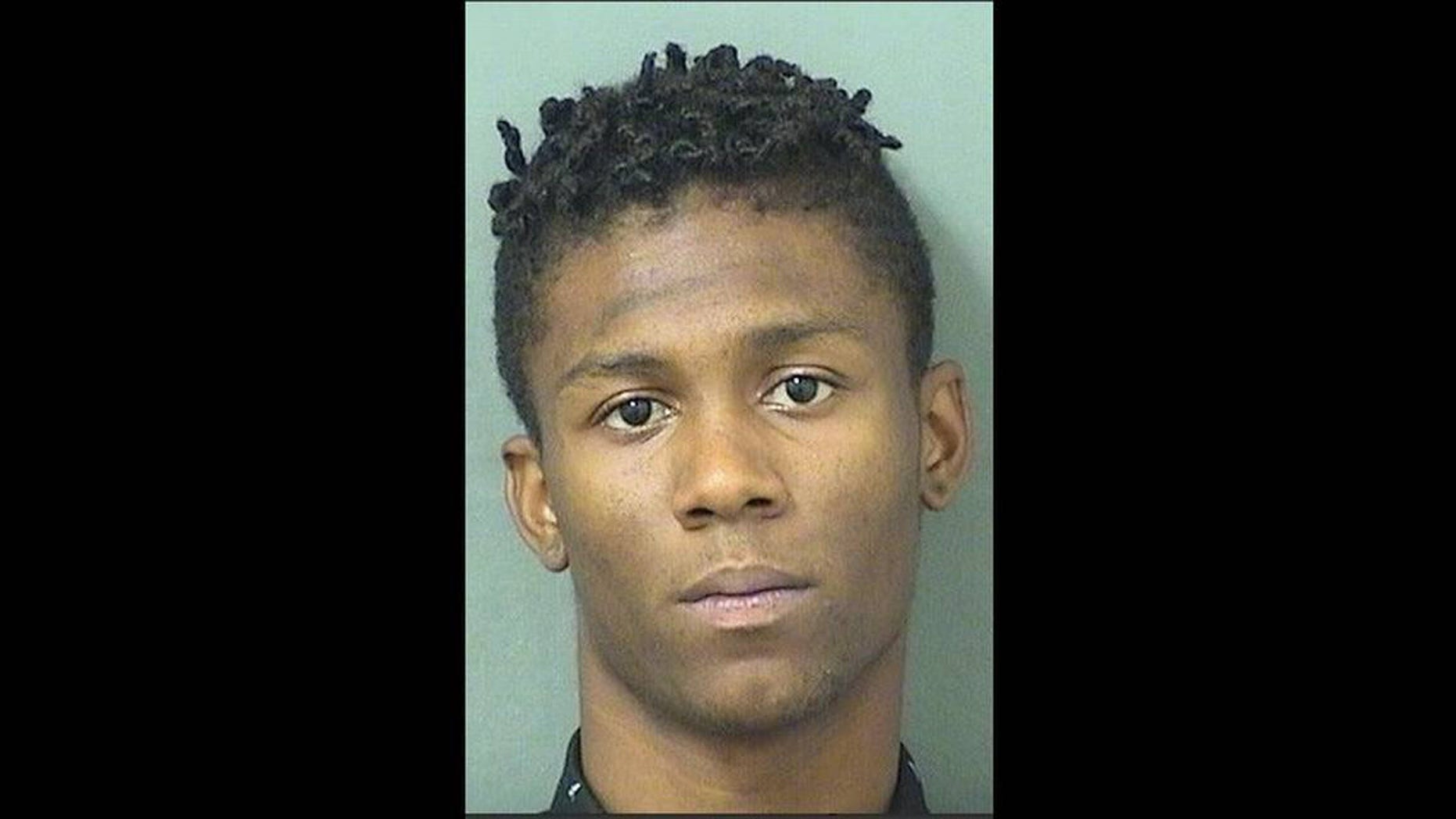 Xavier Martin, 19, was arrested after police say he showed his gun to a group of praying football students on the grounds of Palm Beach Lakes Community High School.