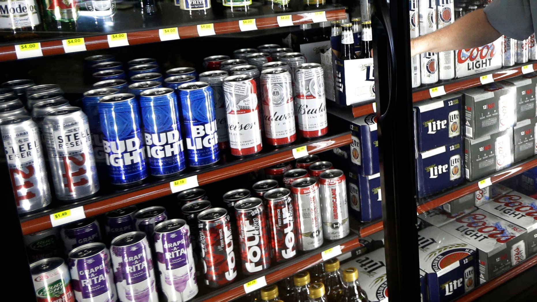 FILE - This Wednesday, April 19, 2017 file photo shows the beer cooler behind the counter in a convenience store in Sheridan, Ind. In future sweltering years with a double whammy of heat and drought, losses of barley yield can be as much as 17 percent, computer simulations show. And that means “beer prices would, on average, double,†even adjusting for inflation, said a study published in the journal Nature Plants on Wednesday, Oct. 17, 2018. (AP Photo/Michael Conroy)