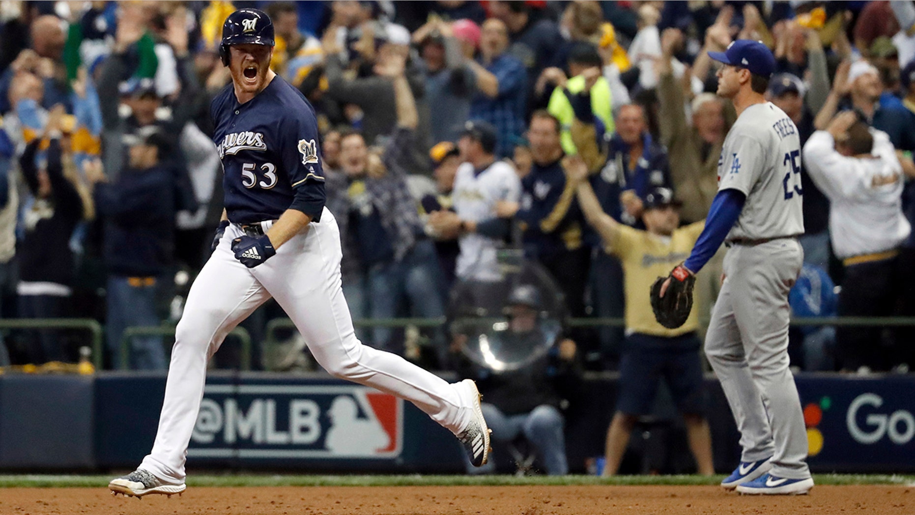 Milwaukee Brewers' Brandon Woodruff (53) celebrates after hitting a home run during the third inning of Game 1 of the National League Championship Series baseball game against the Los Angeles Dodgers Friday, Oct. 12, 2018, in Milwaukee.