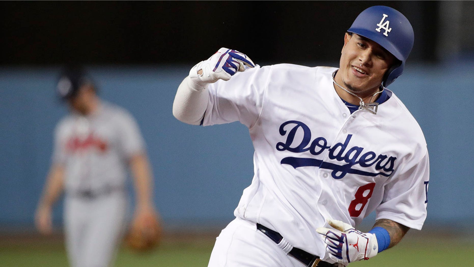 Los Angeles Dodgers' Manny Machado celebrates his two-run home run against the Atlanta Braves during Game 2 of the National League Division Series, in Los Angeles, Oct. 5, 2018.