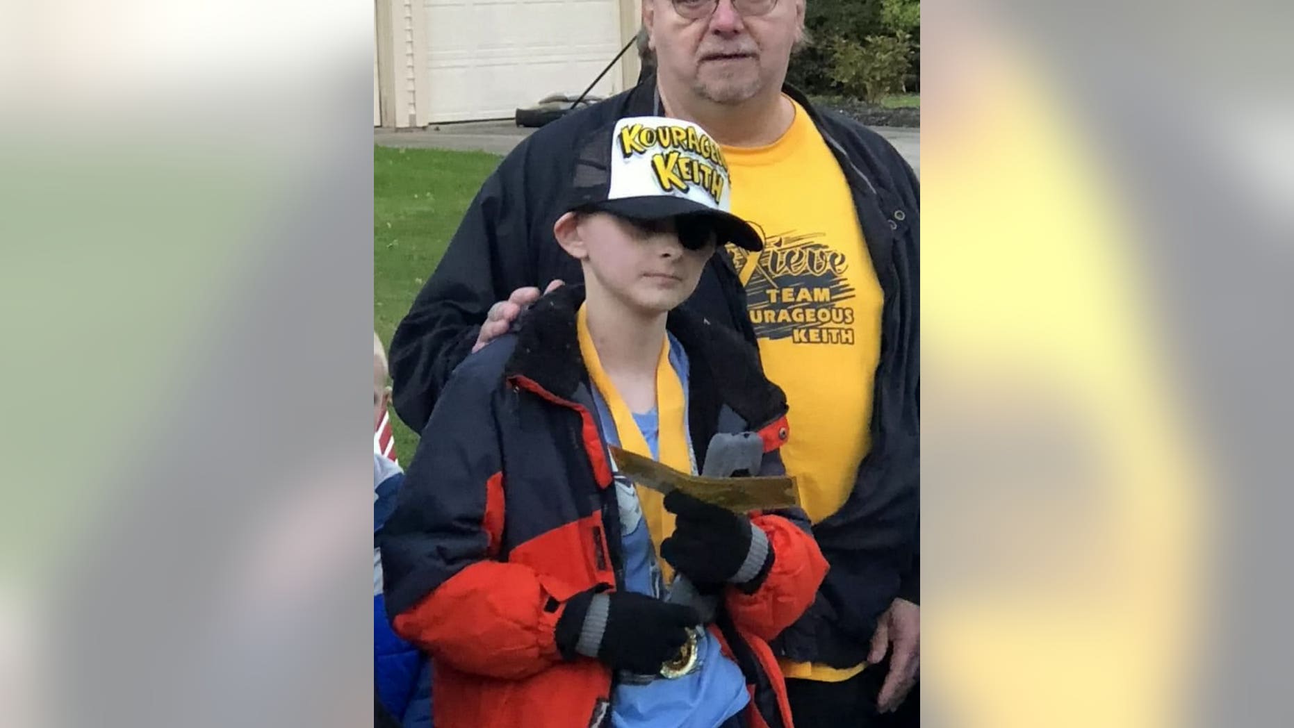 Keith Burkett, 12, holds his Golden Ticket for the Polar Express, which was part of his town's early Christmas celebration held in his honor.