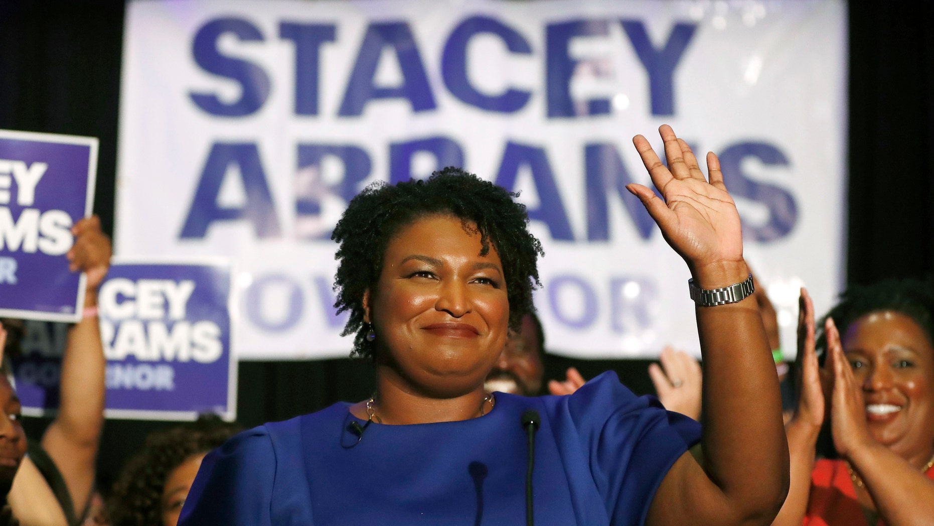 FILE- In this May 22, 2018, file photo Georgia's Democratic gubernatorial candidate Stacey Abrams waves in Atlanta. Abrams is trying to reach voters who don’t usually vote in midterm elections in the hopes to drive up turnout in her race against Republican Brian Kemp. (AP Photo/John Bazemore, File)