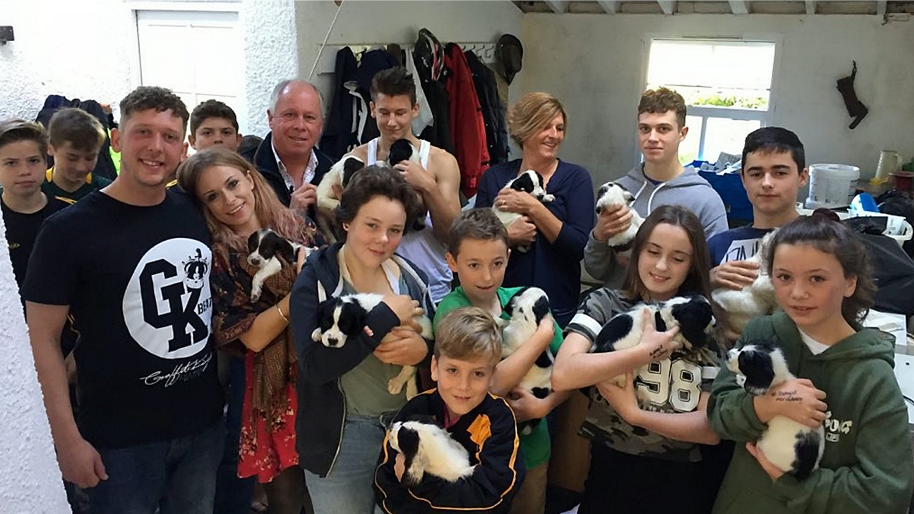 A litter of 14 pups orphaned when their mother died giving birth have been saved after they were hand reared - by an entire village.