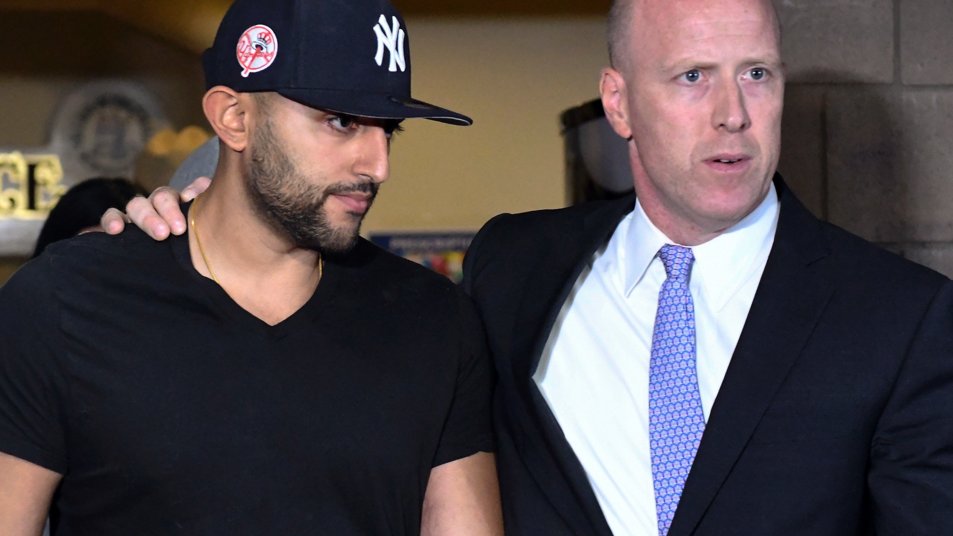 Nauman Hussain, left, leaves Cobleskill Town court with his attorney Lee Kindlon after arraignment Wednesday, Oct. 10, 2018. The limousine service operator, Hussain, was charged Wednesday with criminally negligent homicide in a crash that killed 20 people, while police continued investigating what caused the wreck and whether anyone else will face charges. (AP Photo/Hans Pennink)