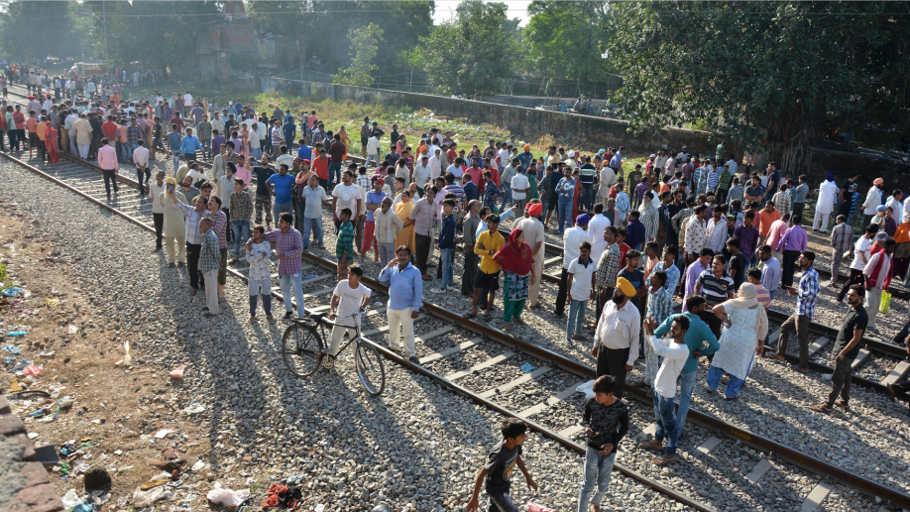 A crowd gathers at the site of Friday's train accident in Amritsar, India, Saturday, Oct. 20, 2018. A speeding train ran over a crowd watching fireworks during a religious festival in northern India on Friday evening, killing more than 50 people and injuring dozens more, police said.