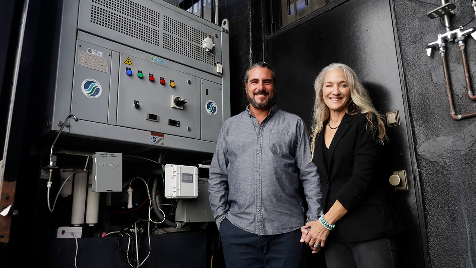 The Skysource/Skywater Alliance co-founders David Hertz, left, and his wife Laura Doss-Hertz pose for a portrait next to the Skywater 300 Wednesday in Los Angeles.