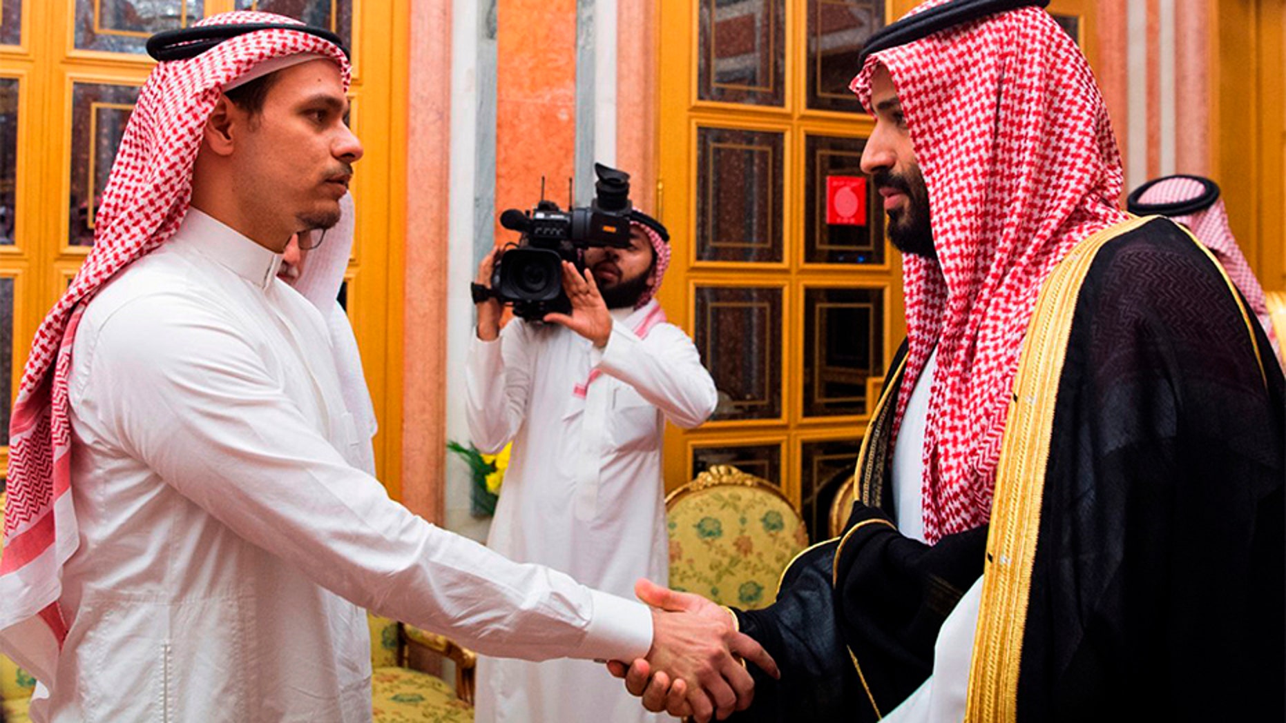 Saudi Crown Prince Mohammed bin Salman, right, shakes hands with Salah Khashoggi, a son, of Jamal Khashoggi, in Riyadh, Saudi Arabia.