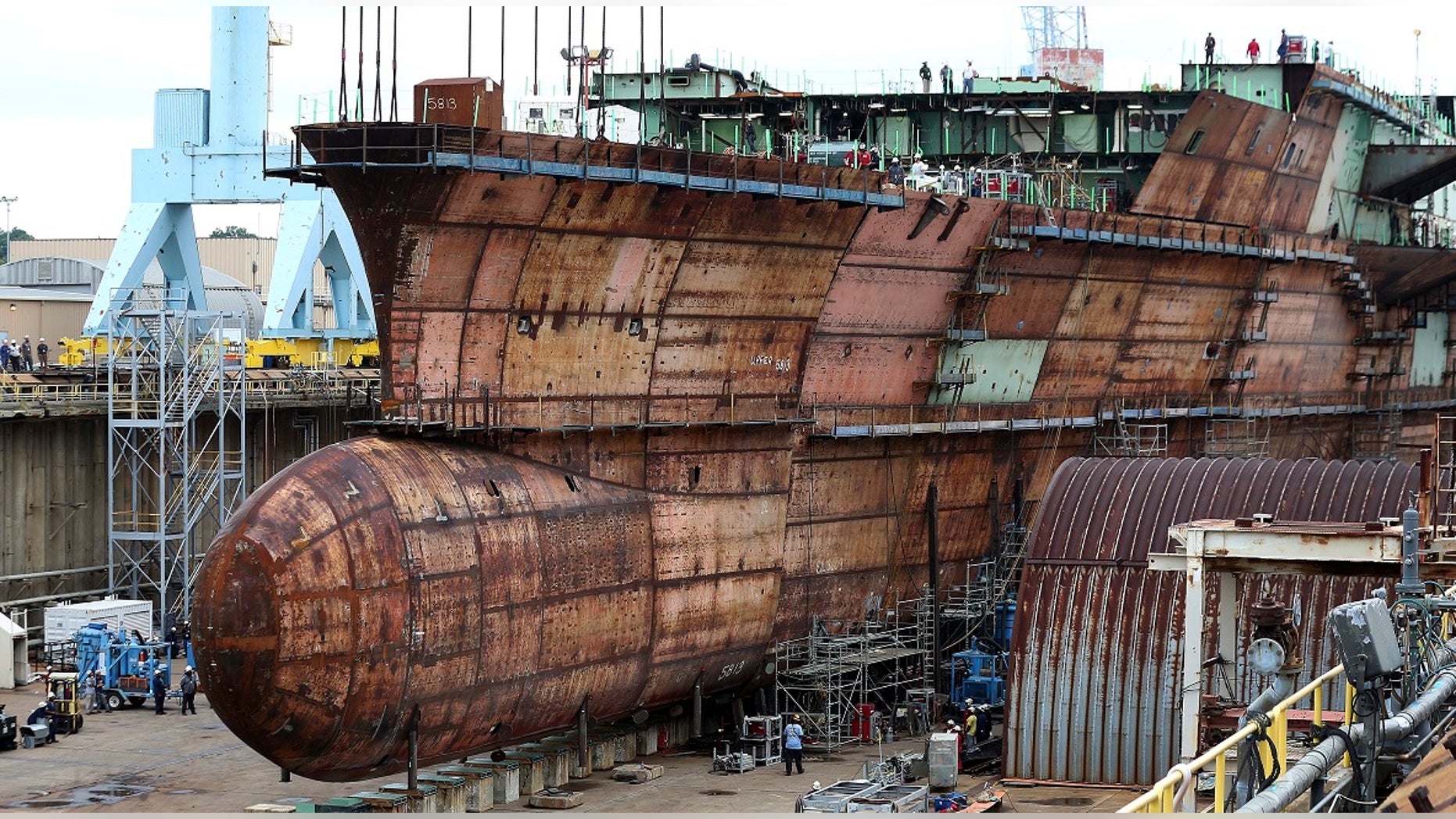 The underwater hull in the U.S. aircraft carrier John F. Kennedy is complete after the lower bow section was placed, in Newport News, Va., Sept. 28, 2018.
