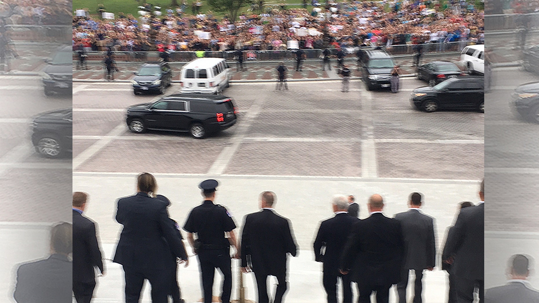 Vice President Mike Pence says “Let’s do it” and walks down Senate steps toward a sea of protesters shouting “Shame! Shame! Shame!”