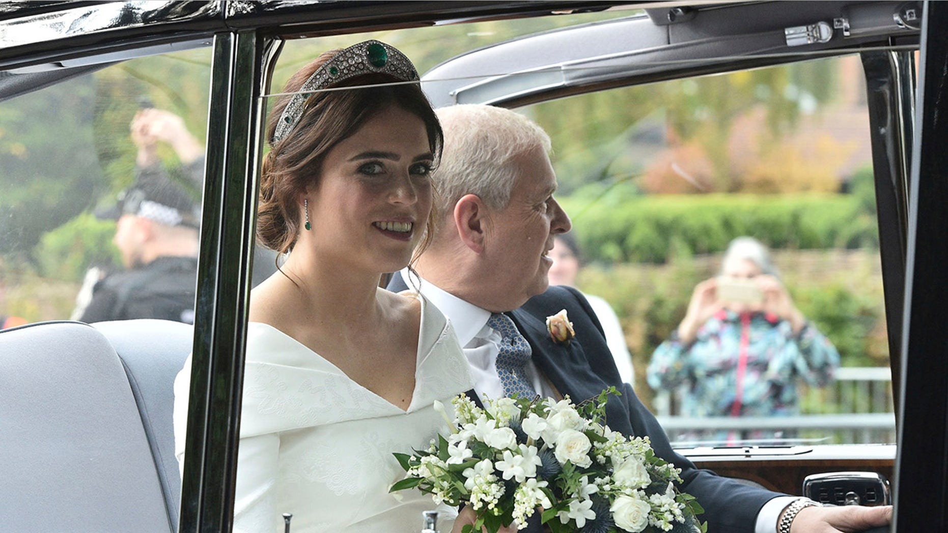 Princess Eugenie of York, left, arrives with her father Prince Andrew, Duke of York for her wedding with Jack Brooksbank in St George's Chapel, Windsor Castle, near London, England, Friday, Oct 12, 2018. (Ben Birchall/PA via AP)<br>