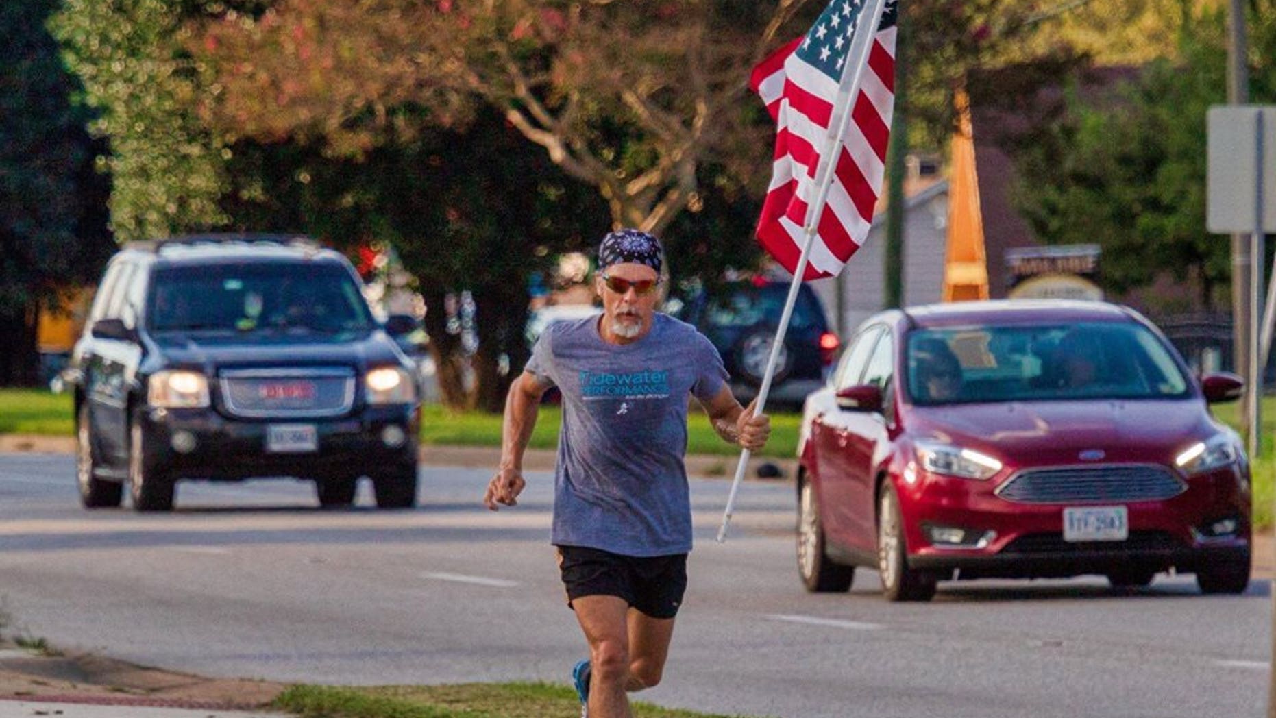 Virginia man Wayne Parfitt runs with the flag in hand to honor his son, who is deployed overseas.