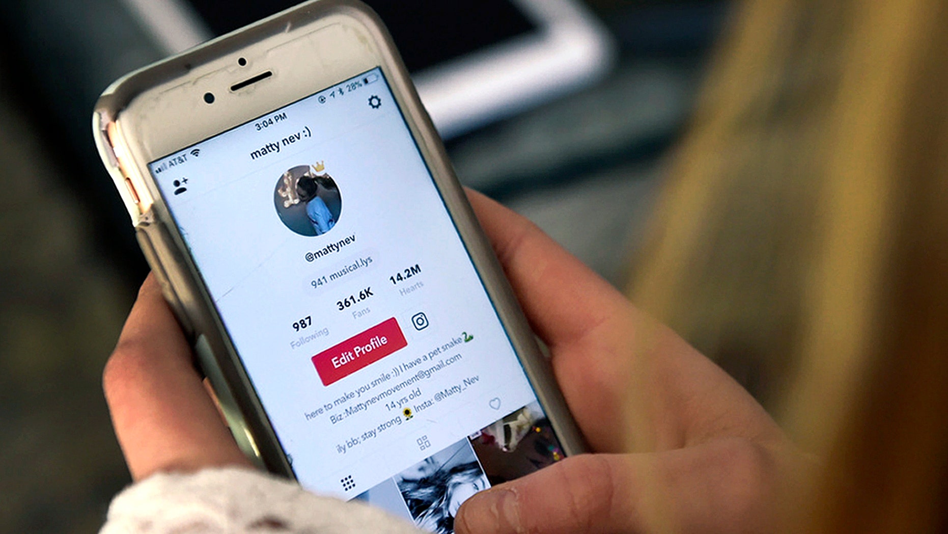 In this Feb. 28, 2018 photo, Matty Nev Luby holds her phone and logs into the lip-sync smartphone app Musical.ly, in Wethersfield, Conn. Teens and young adults say cyberbullying is a serious problem for people their age, but most don’t think they’ll be the ones targeted for digital abuse. The high school gymnast’s popularity on the lip-syncing app Musical.ly, which merged this summer into the Chinese video-sharing app TikTok, helped win her some modeling contracts. Luby said she's learned to navigate Instagram and other social media apps by brushing aside the anonymous bullies. (AP Photo/Jessica Hill)