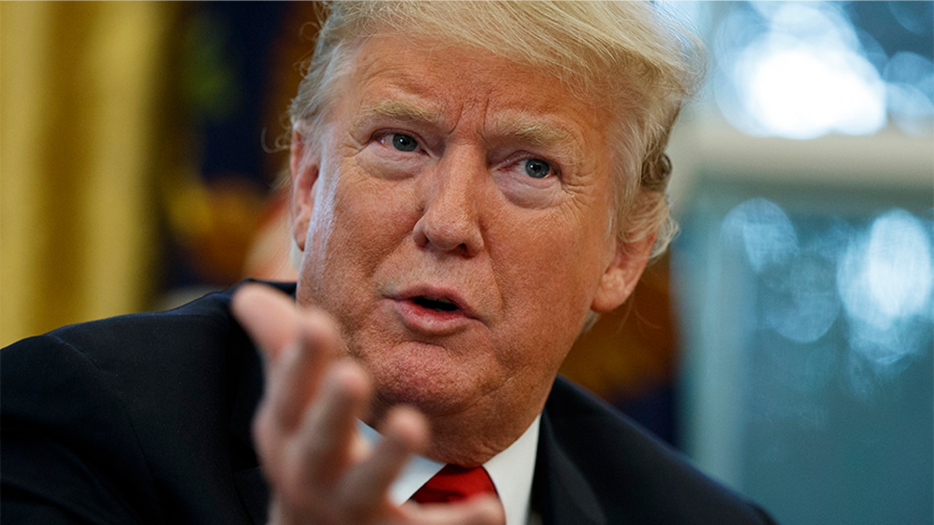 President Donald Trump speaks during an interview with The Associated Press in the Oval Office of the White House, Tuesday, Oct. 16, 2018, in Washington.