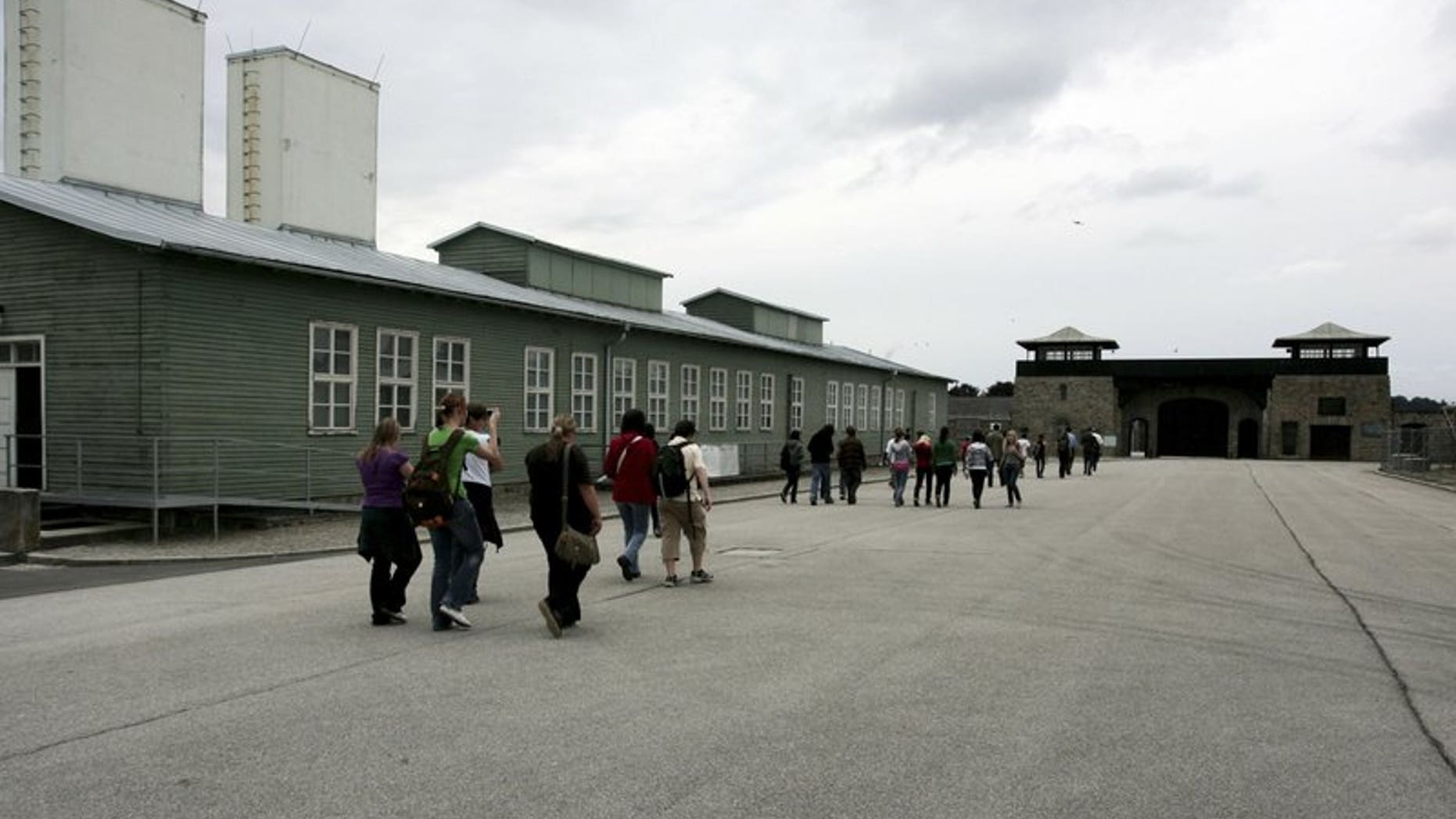 In this June 17, 2008 file photo, young people and participants of a conference of the Task Force for International Cooperation on Holocaust Education, Remembrance and Research visit the former Nazi concentration camp in Mauthausen, Austria.